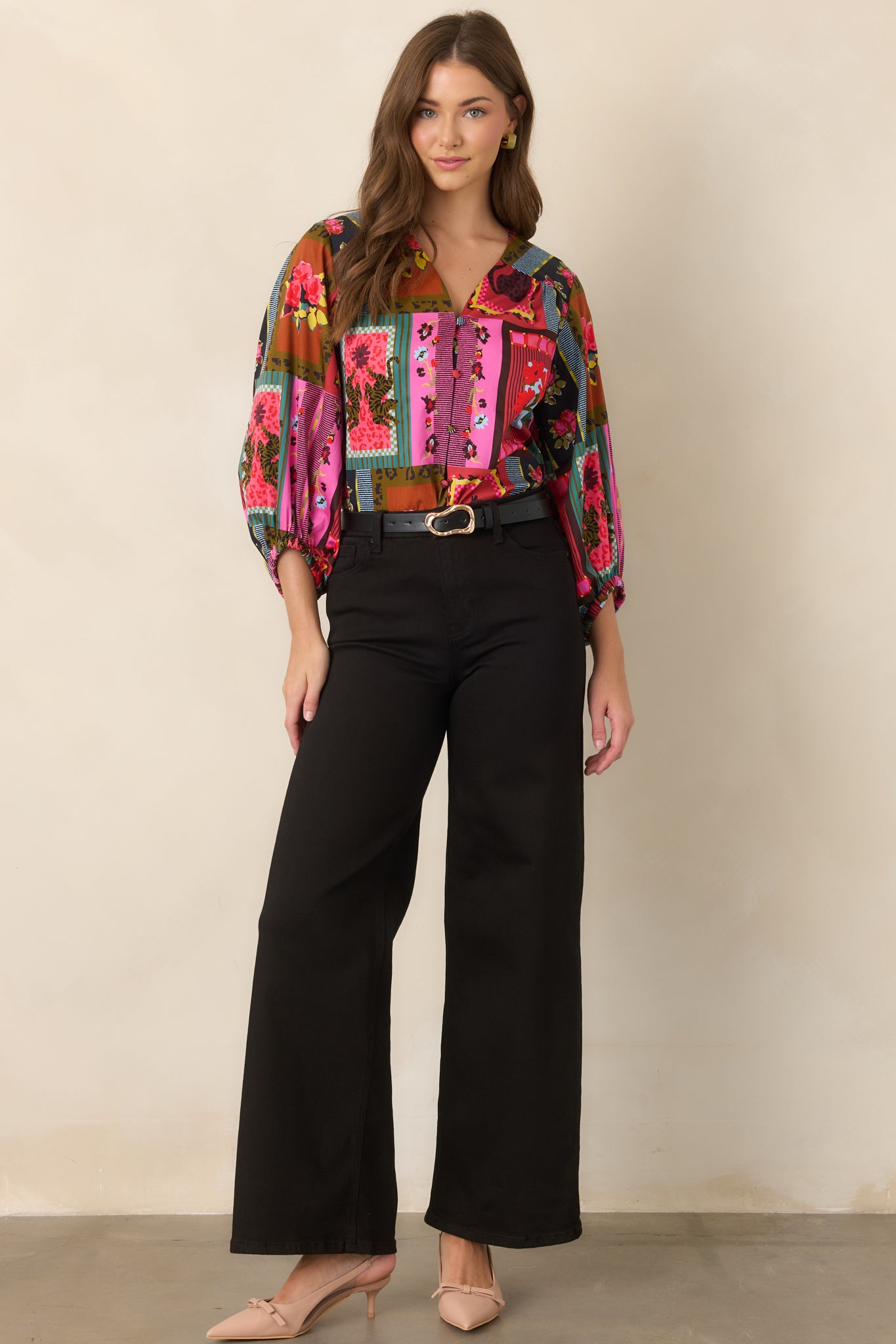 Colorful patchwork-inspired blouse showcasing a mix of florals, stripes, framed motifs, and playful animal accents across its relaxed silhouette.