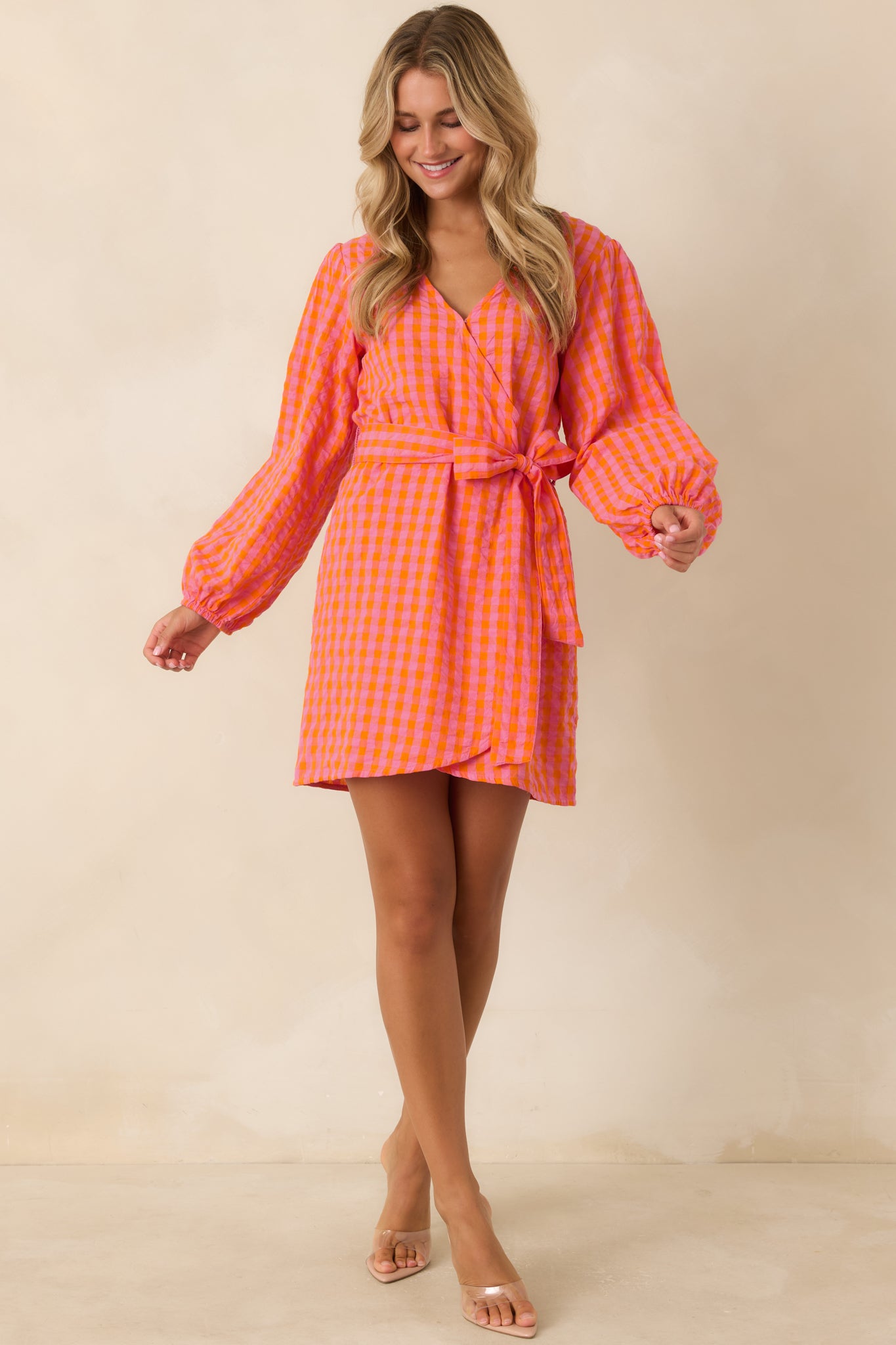 Colorful cotton wrap mini dress showcasing a V-neckline, adjustable self-tie waist, and a feminine tulip-style wrap skirt.