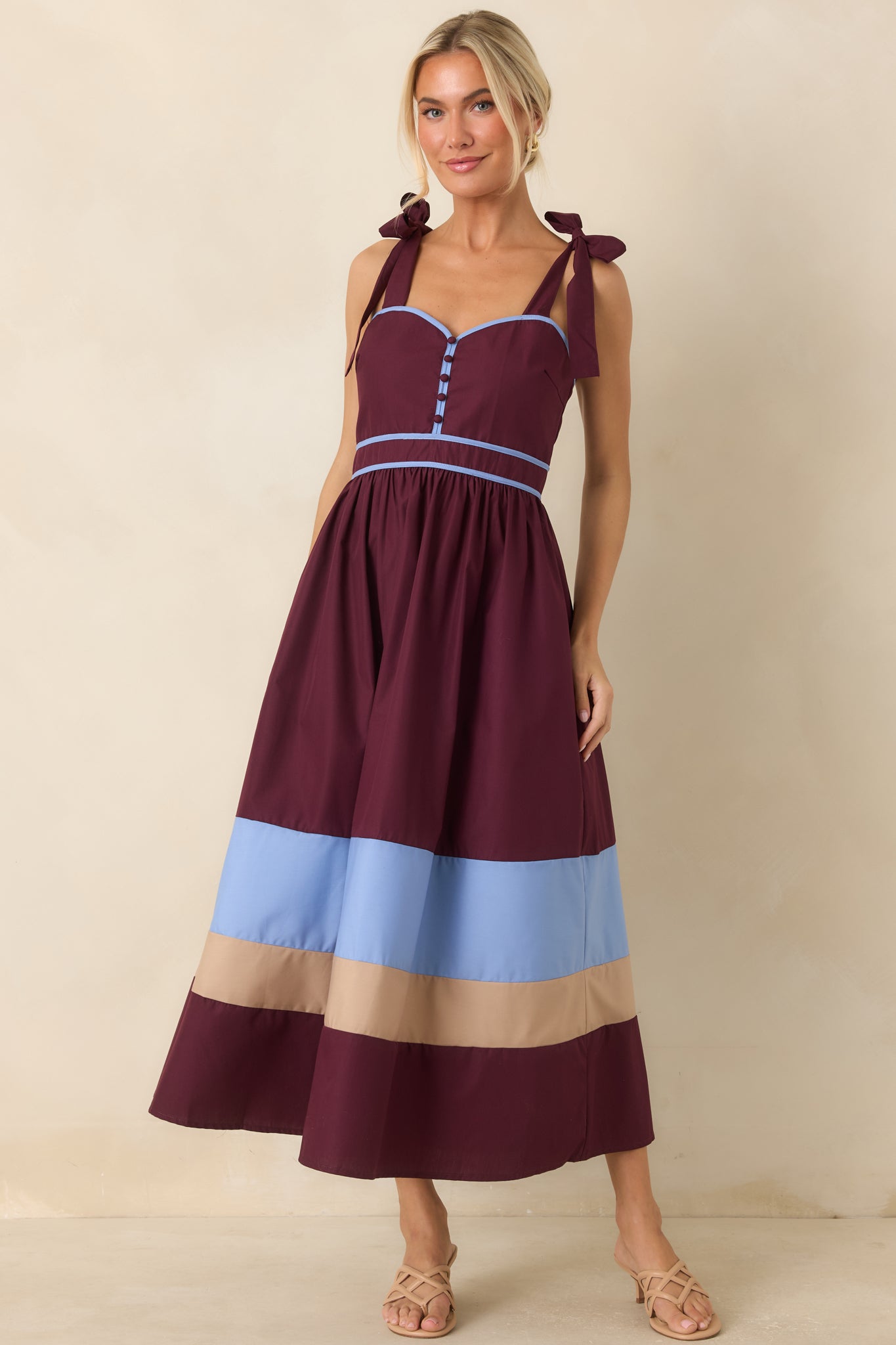 Contrast strap midi dress featuring adjustable self-tie shoulders, smocked back design, and bold striped hem detailing.