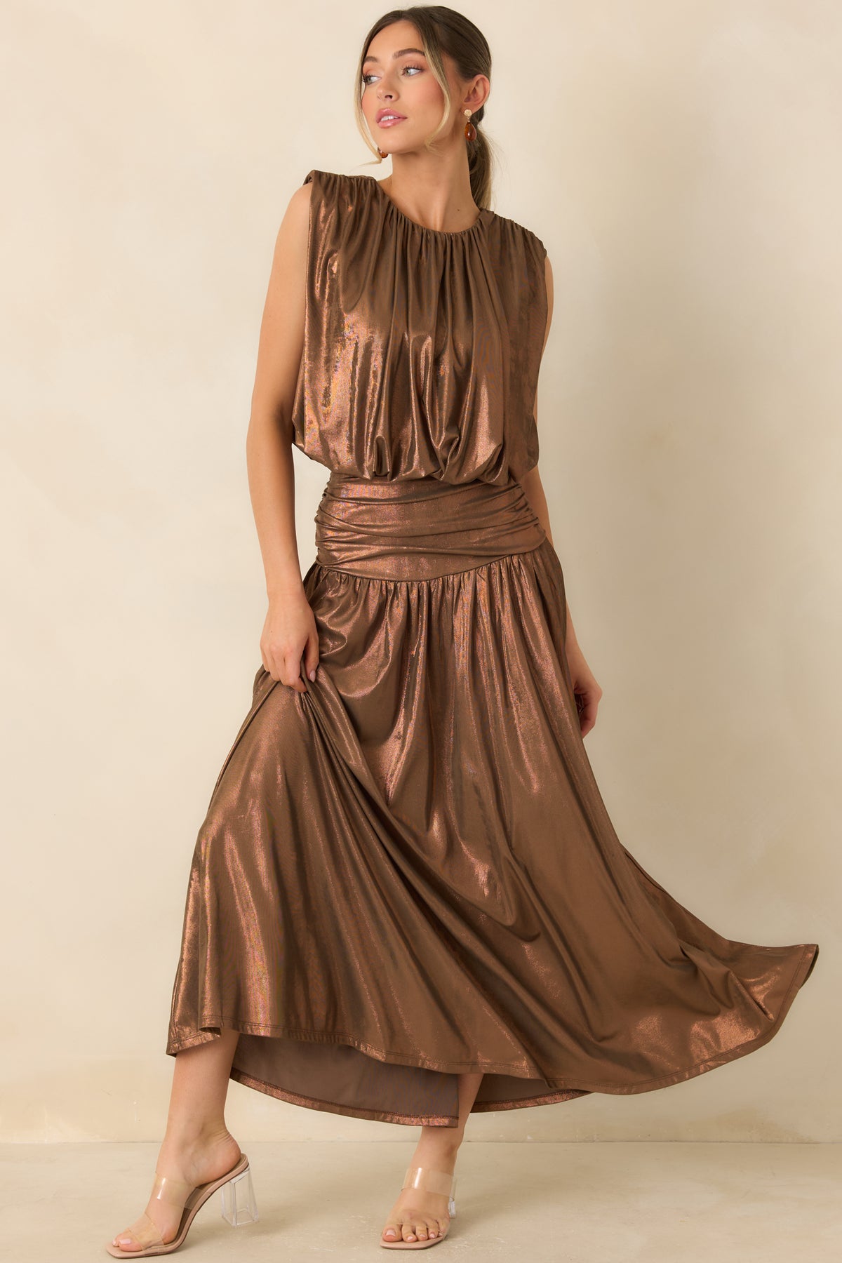 Copper-shimmer maxi skirt with a wide textured waistband and softly gathered fabric that creates fluid movement.