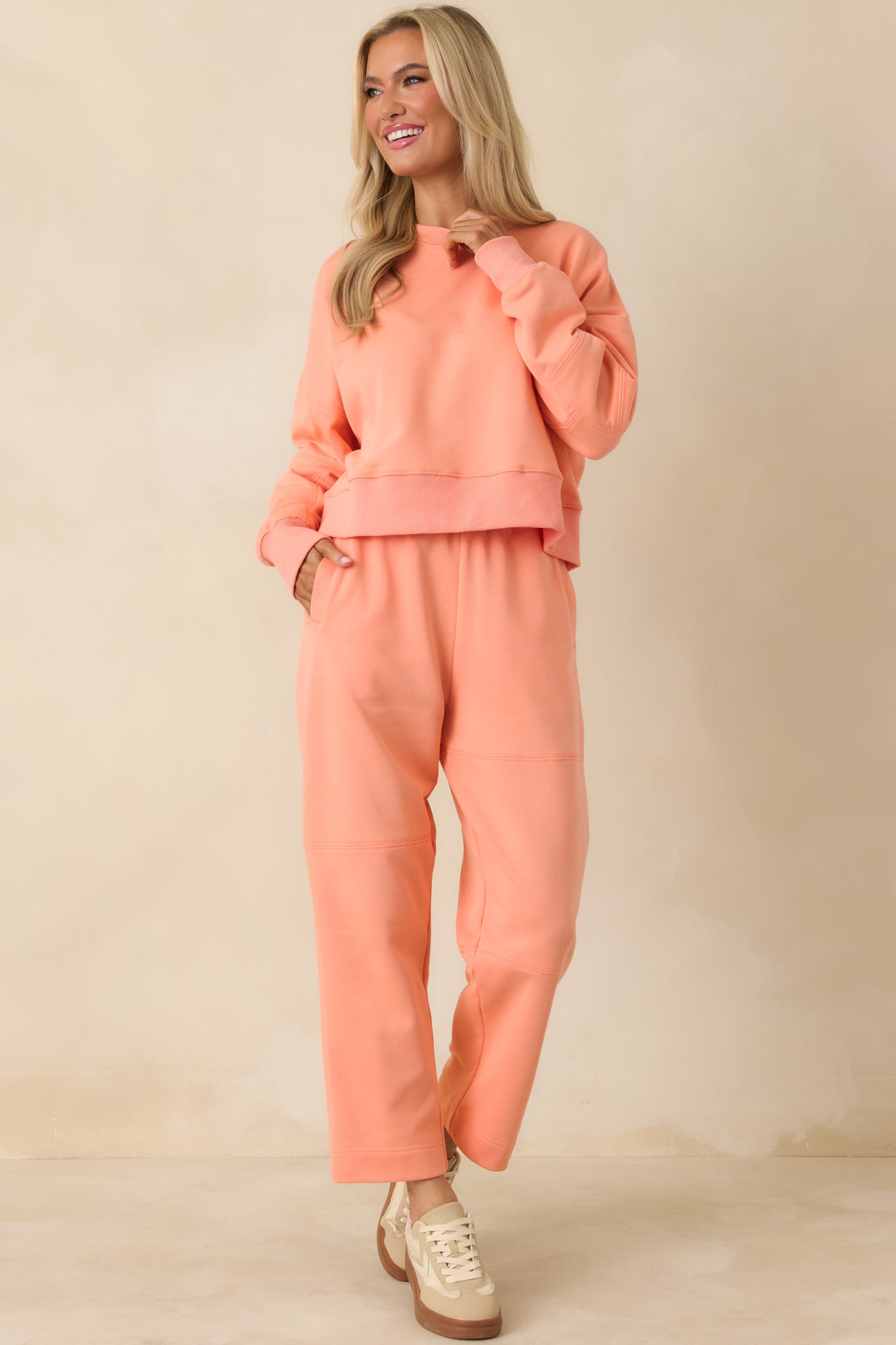 Pull-on coral sweatpants with relaxed fit and block-stitched seam detailing.