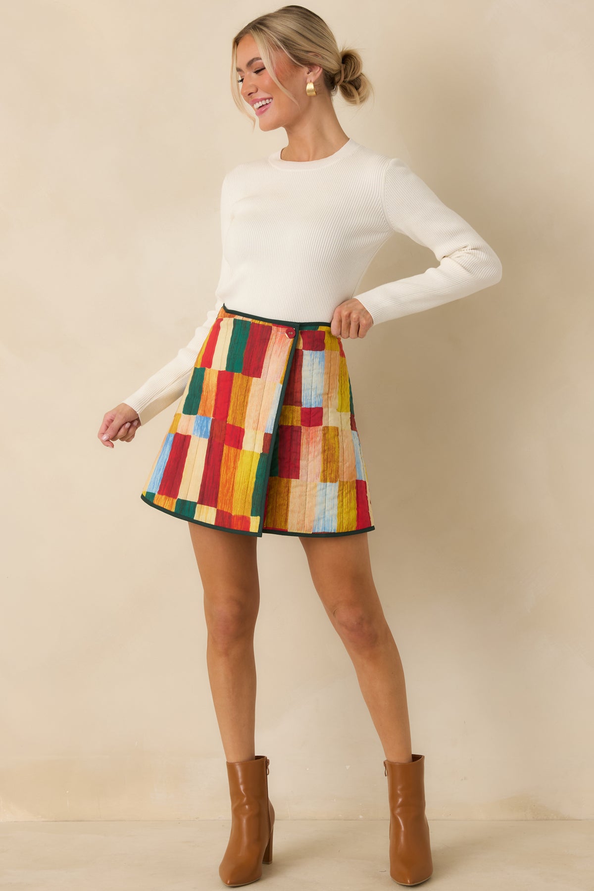 A-line cotton skirt showcasing colorful geometric artwork, quilted stitching, and a neatly framed wrap front.