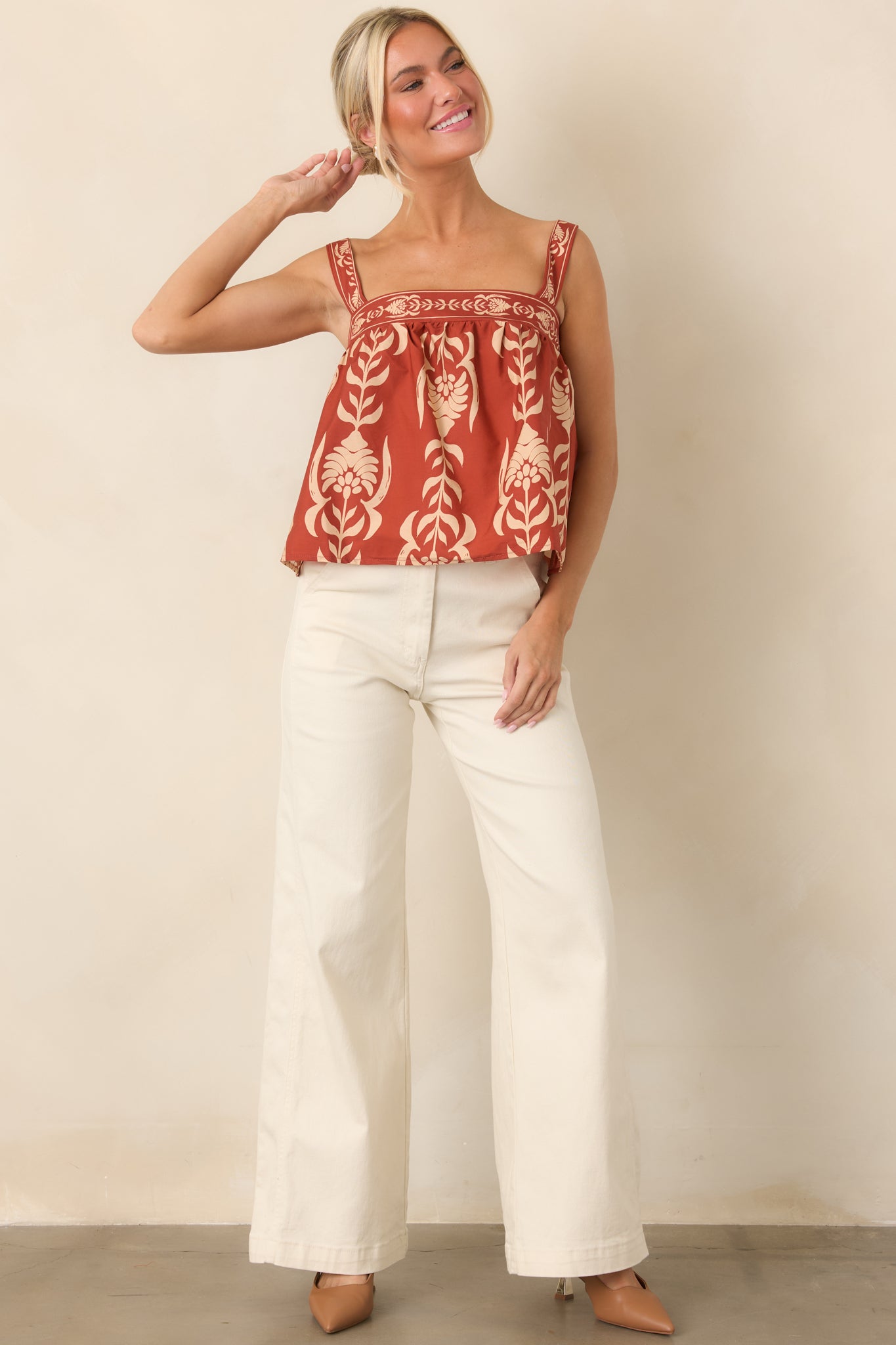 100% cotton babydoll top featuring a square neckline, wide straps, gathered silhouette, and softly flared hem.