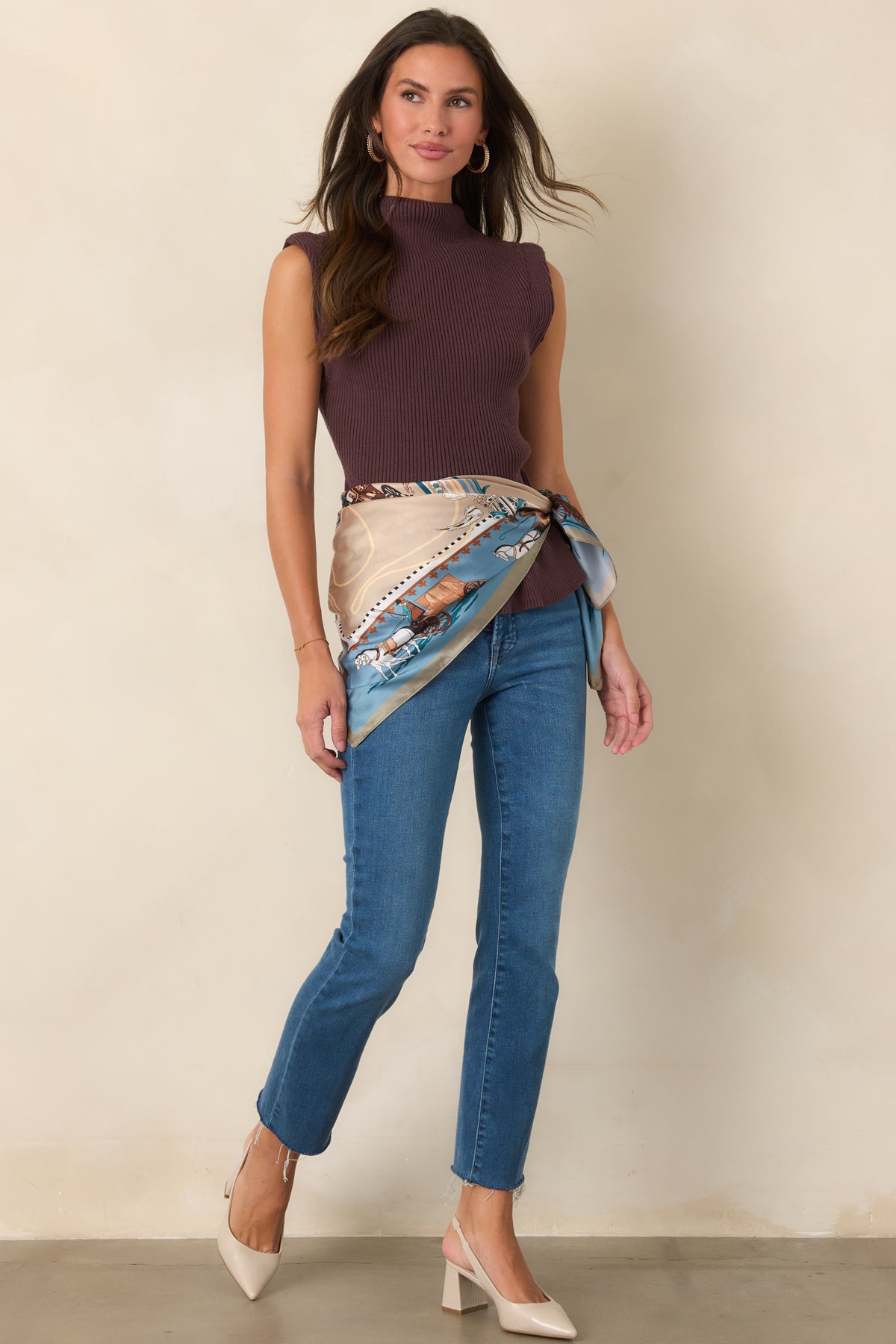 Cotton-blend top designed with a fitted ribbed bodice, sleeveless silhouette, and mock neckline.