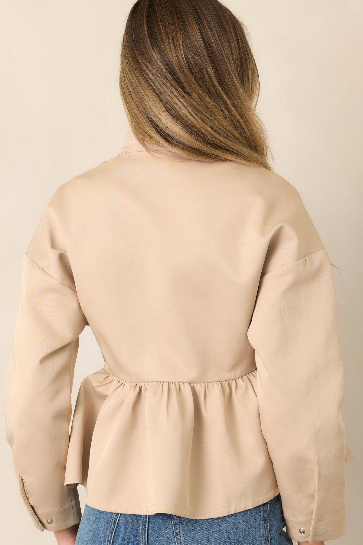 Rear of cotton-blend jacket showing dropped shoulders and gathered peplum hem.
