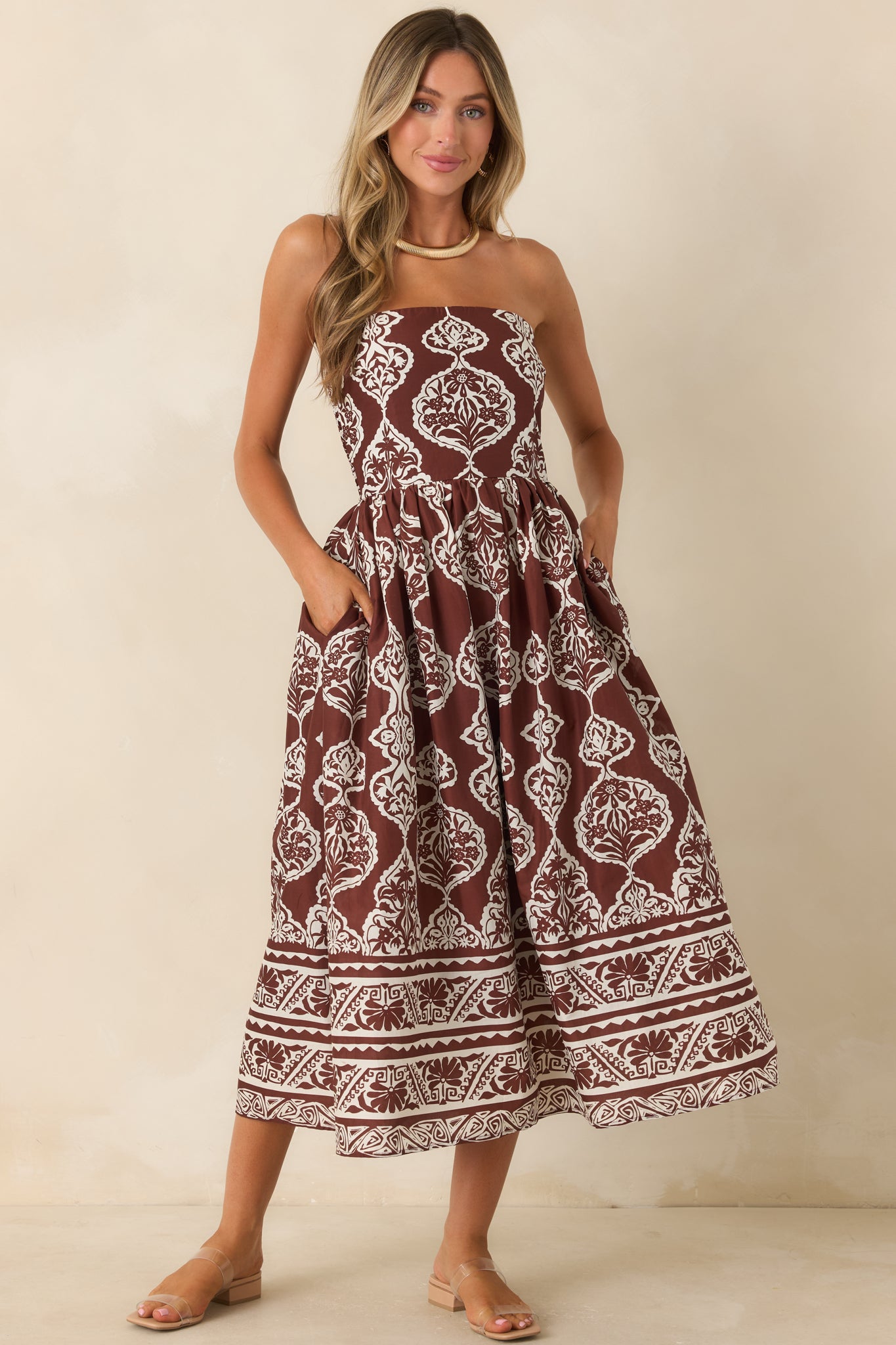 Cotton-blend strapless dress with a flexible fitted bodice, concealed zipper, and softly flowing midi skirt.