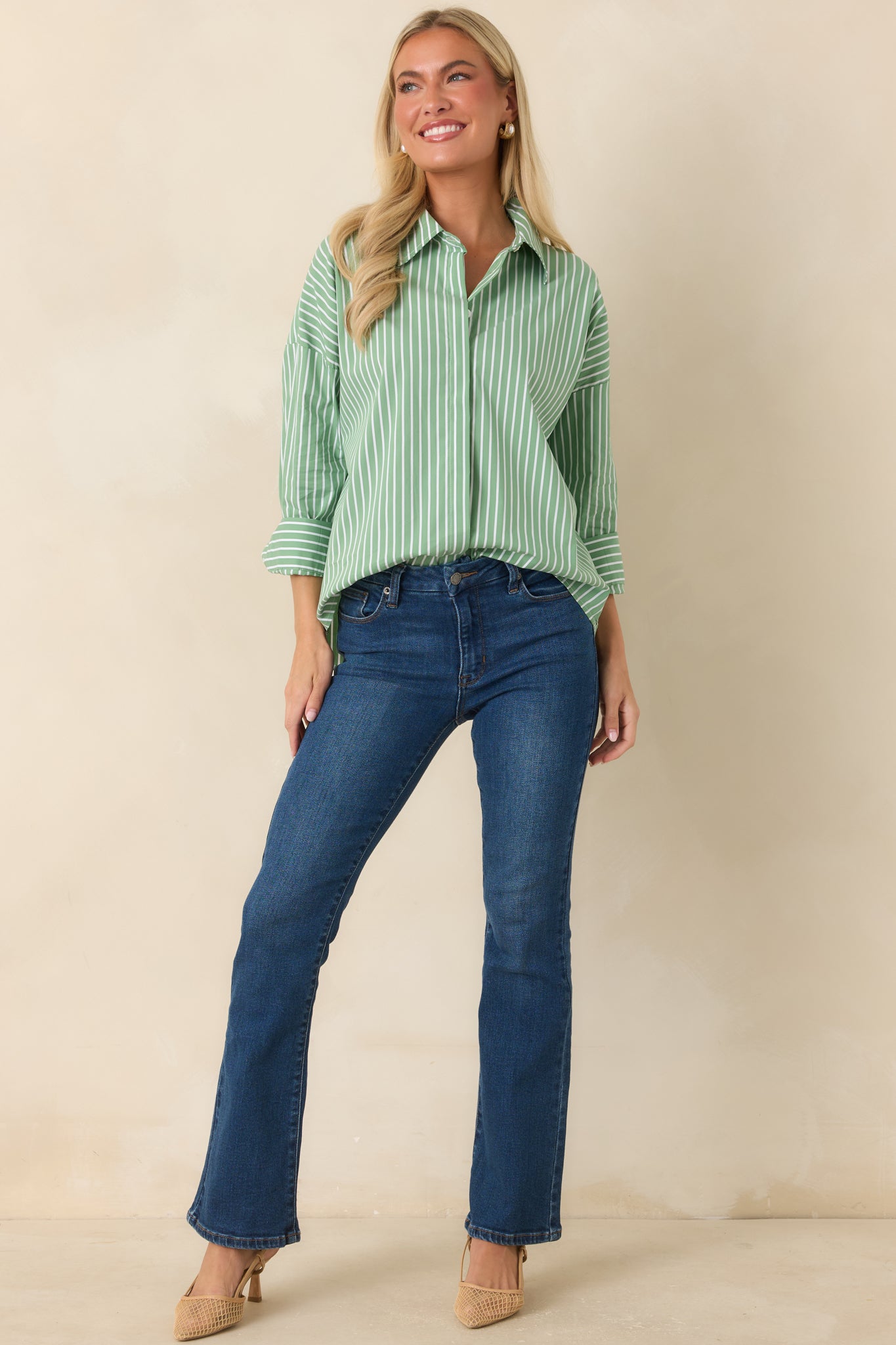 Cotton blend striped top featuring a relaxed silhouette, button cuffs, and a timeless tailored appearance.