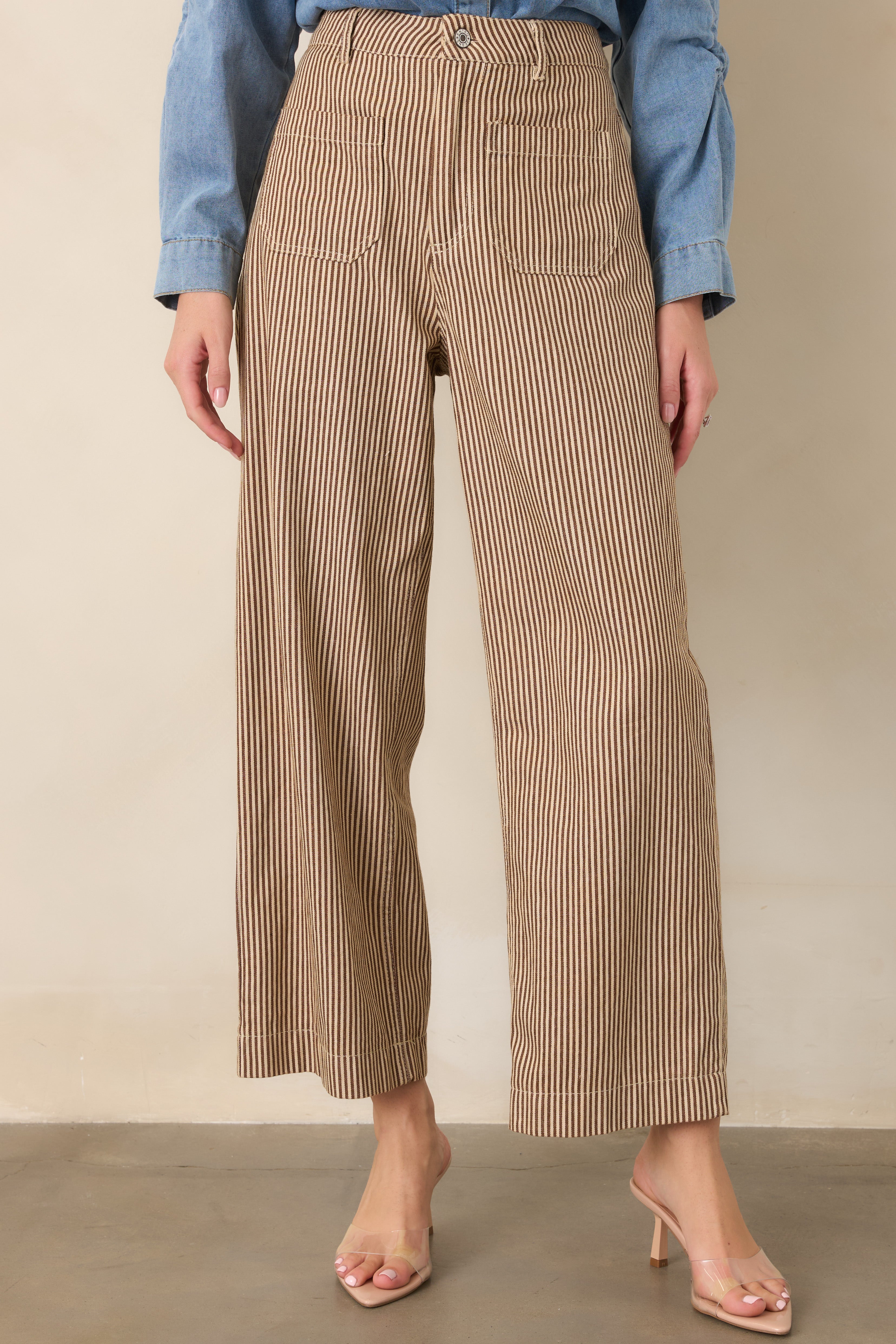 Brown and ivory striped pants highlighting the structured cotton-blend fabric, wide-leg cut, and front patch pocket detailing.