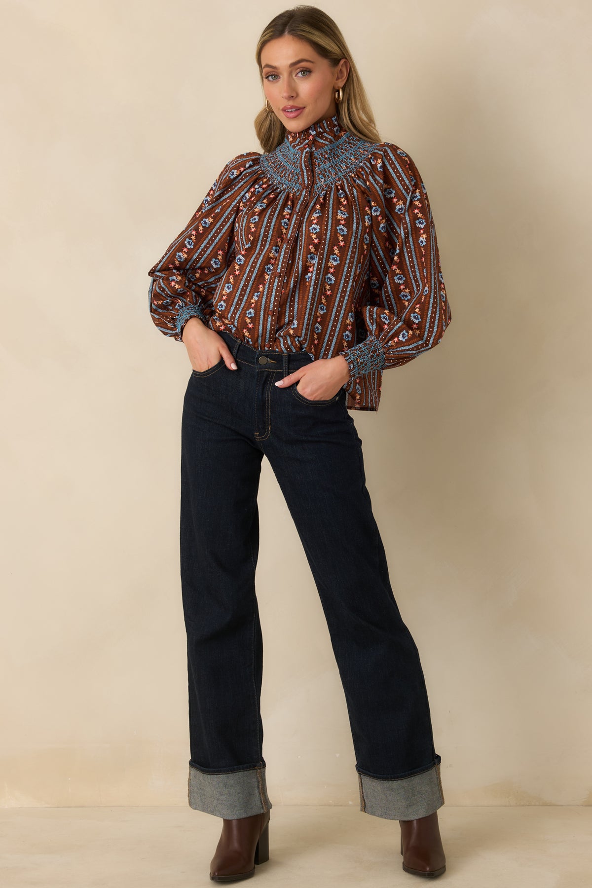 100% cotton blouse showcasing delicate blue and orange floral stripes, voluminous balloon sleeves, and wide smocked cuffs.