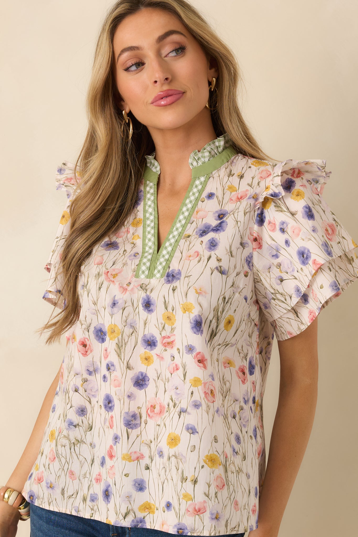 Cotton blouse with cap sleeves featuring gentle ruffle edges for a playful, airy sleeve finish.