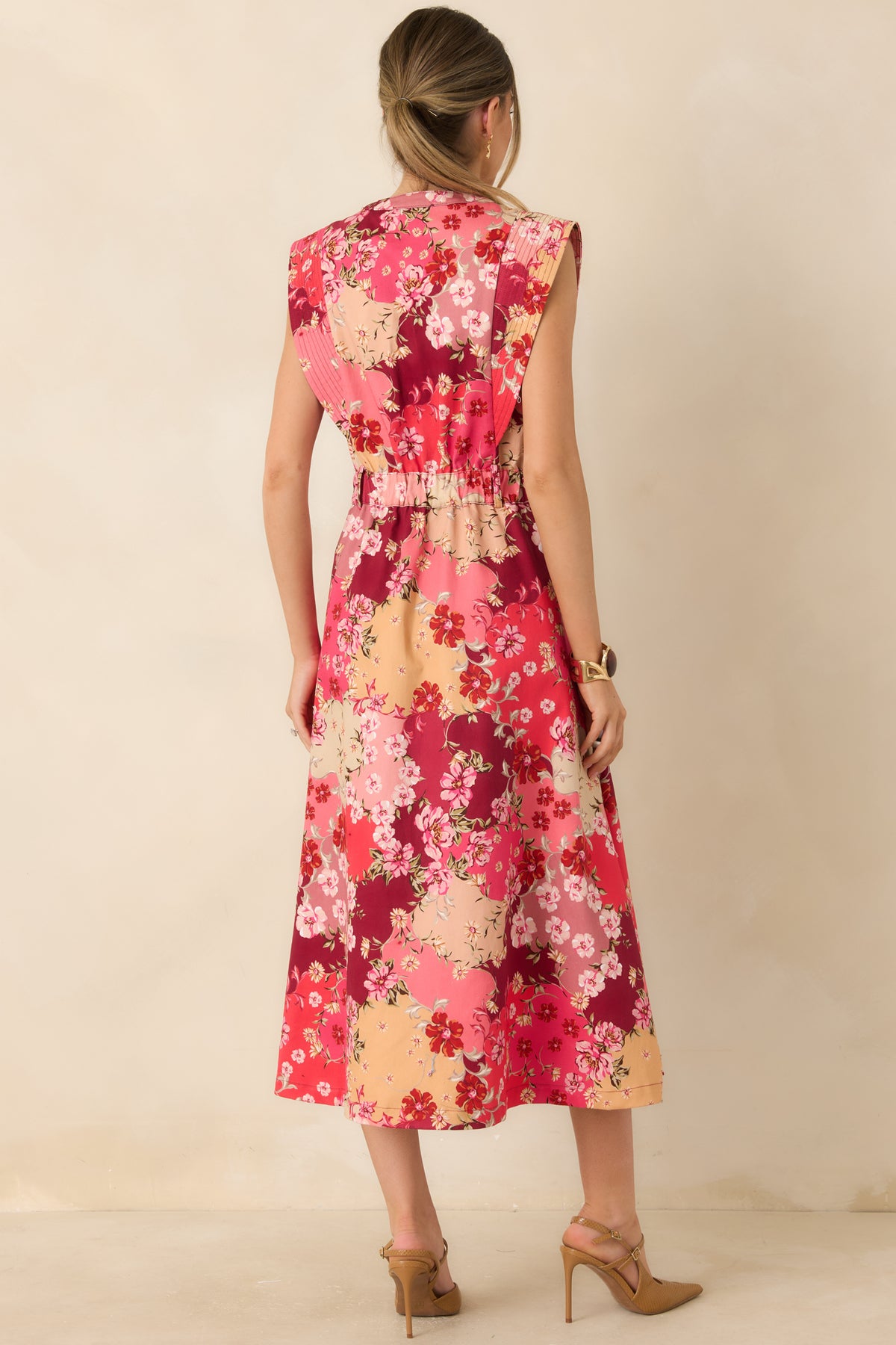 Close-up of the cotton denim’s pink, burgundy, peach, and cream floral print with delicate blossoms and leafy accents.