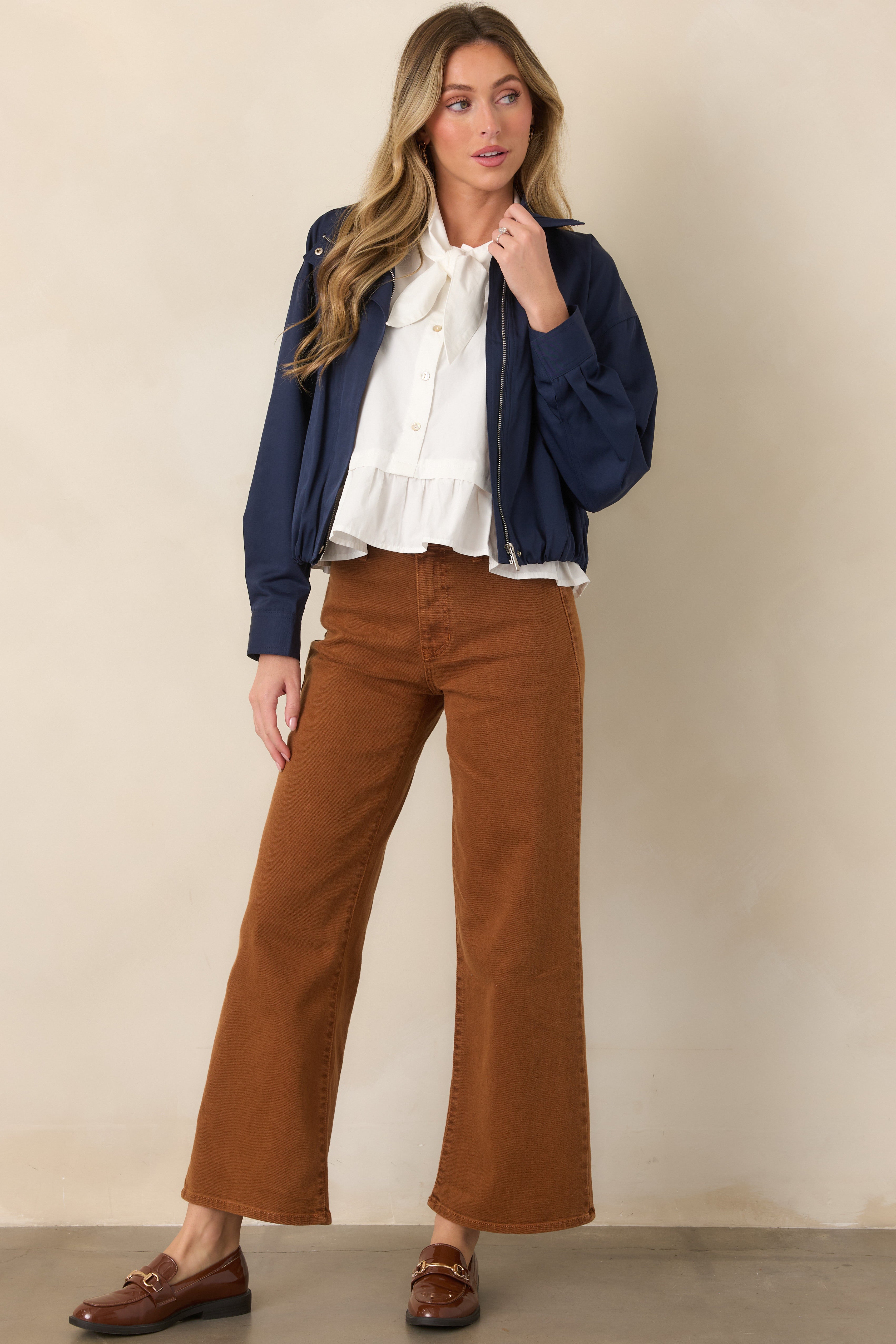 Cotton-rich denim pants with a high-rise fit, traditional pockets, belt loops, and generously wide legs finished at the ankle.