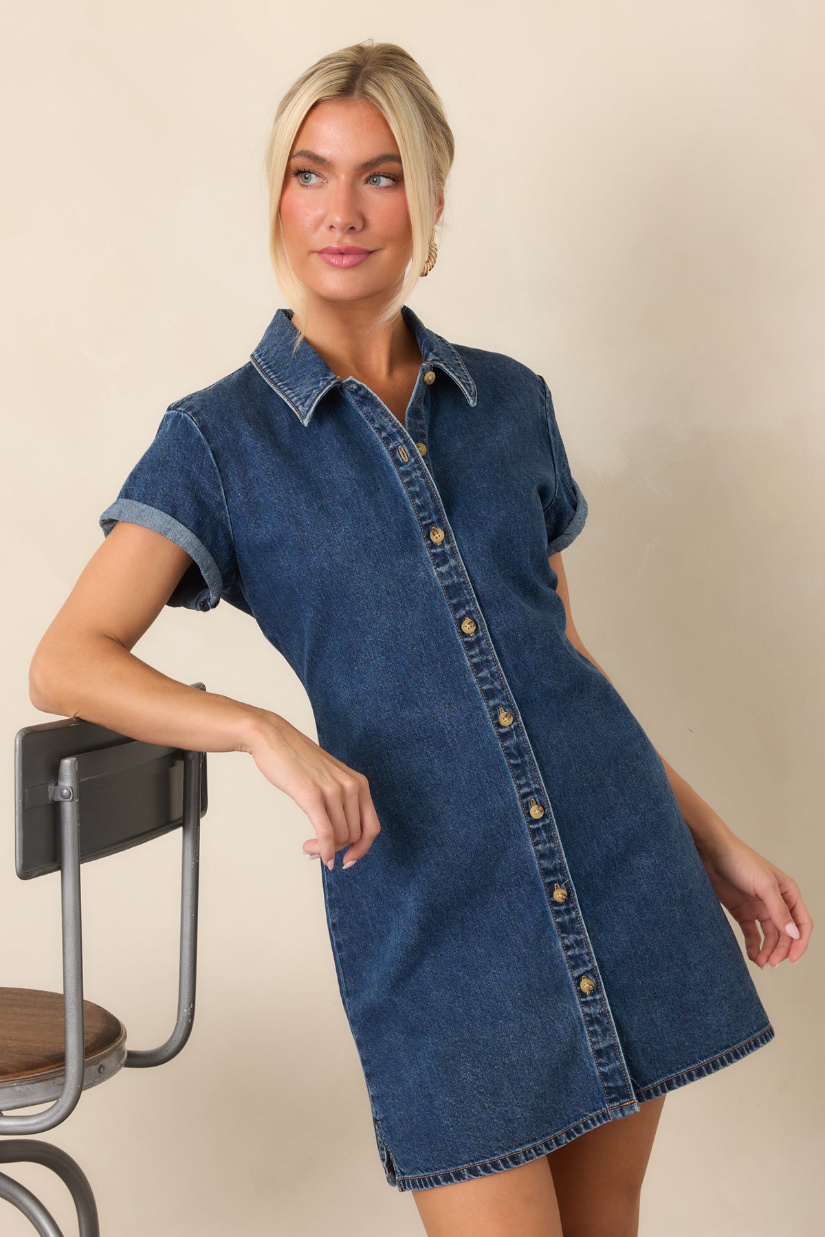 Cotton denim mini dress showcasing a relaxed A-line silhouette and short sleeves.
