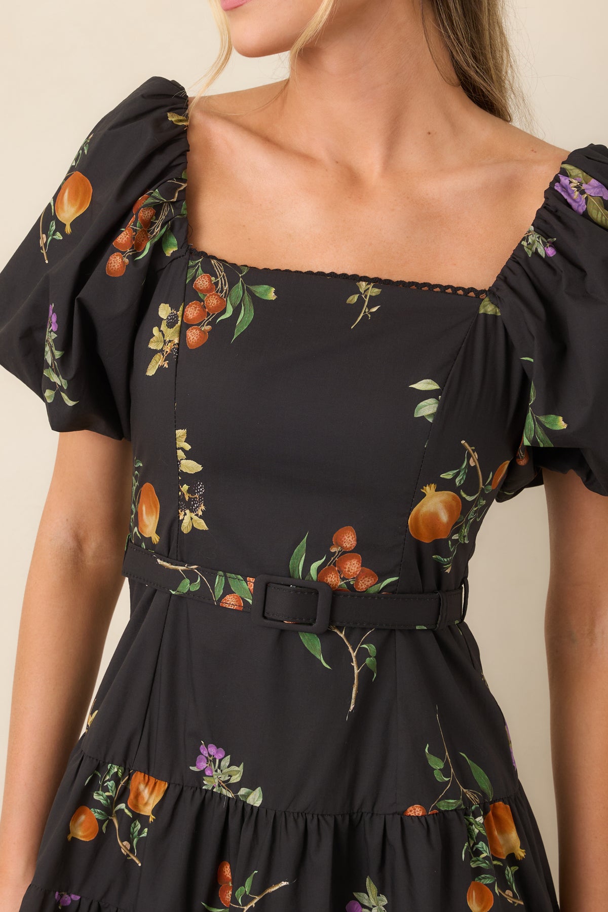 Close-up of the cotton dress highlighting the delicate trim around the square neckline and detailed princess seams.