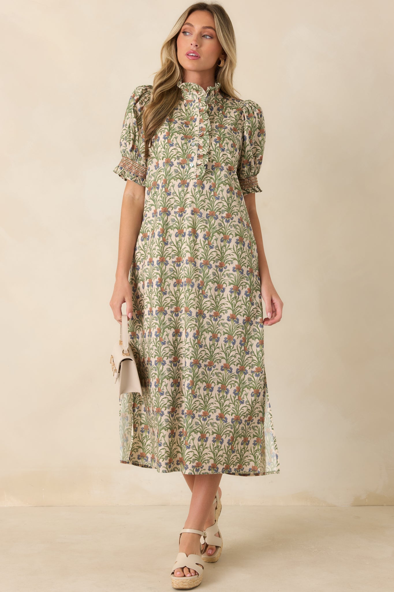 100% cotton dress with an earthy floral-inspired print, partial button front, smocked sleeve cuffs, and a flowing lined skirt.