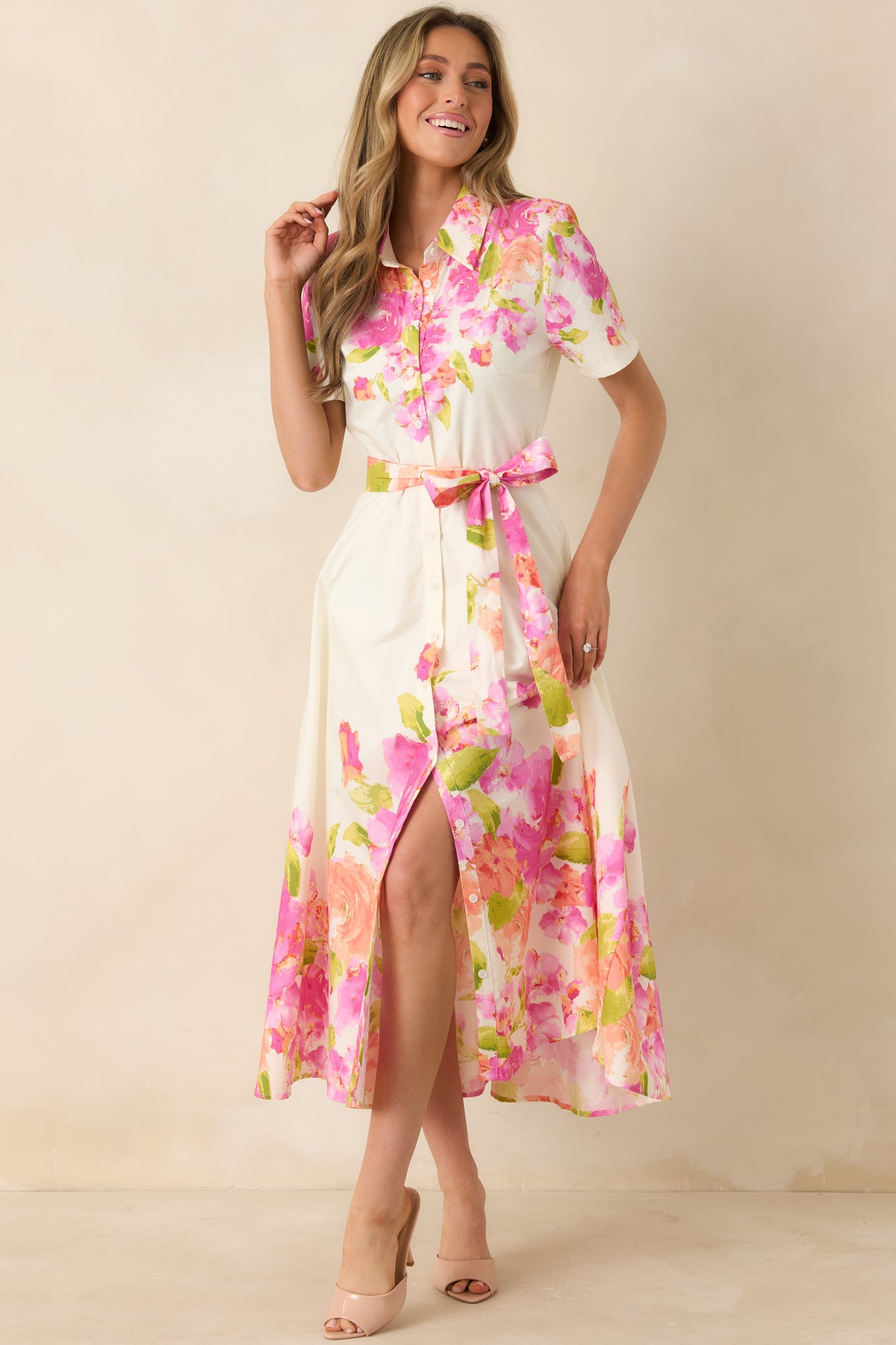 100% cotton dress with collared neckline, button-front bodice, midi-length skirt, and vibrant floral hem.