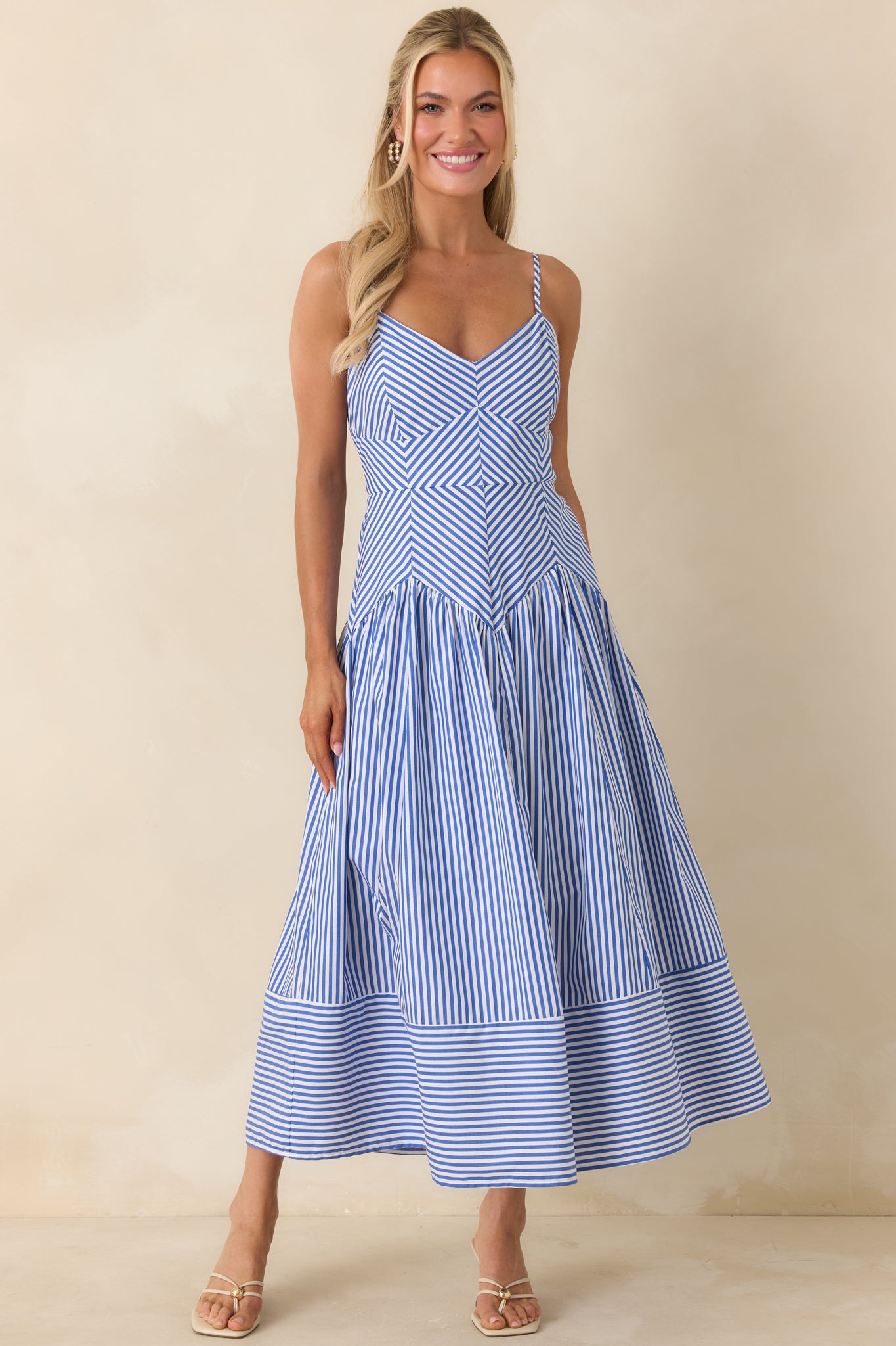 Summer-ready cotton dress with geometric stripes, spaghetti straps, and breathable fabric.