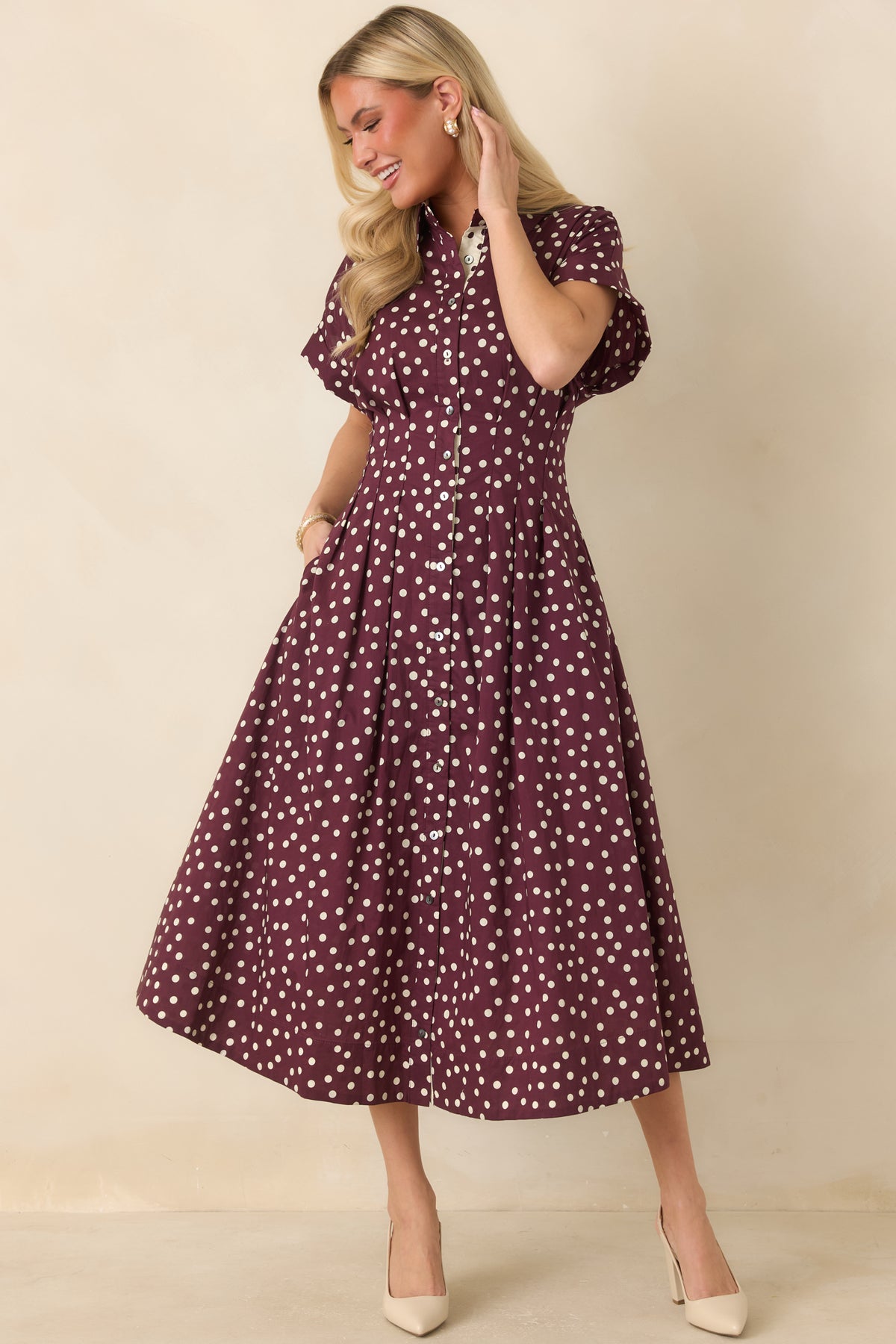 Cotton midi dress with a fitted button-front bodice, collared neckline, short sleeves, tailored waist seams, and flowing skirt.