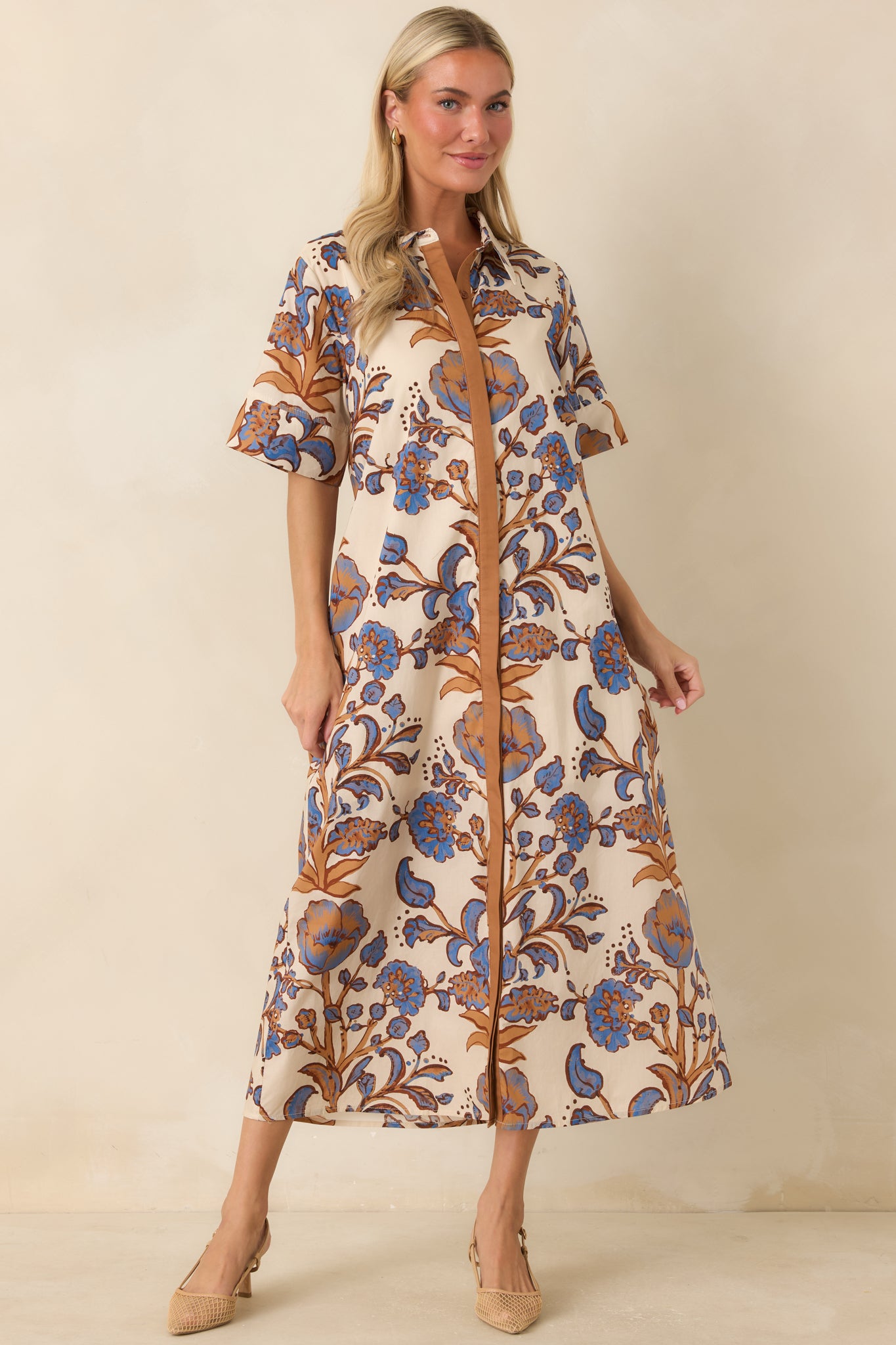 Cotton shirt dress showcasing a bold floral pattern, collared neckline, side pockets, and lightweight breathable design.