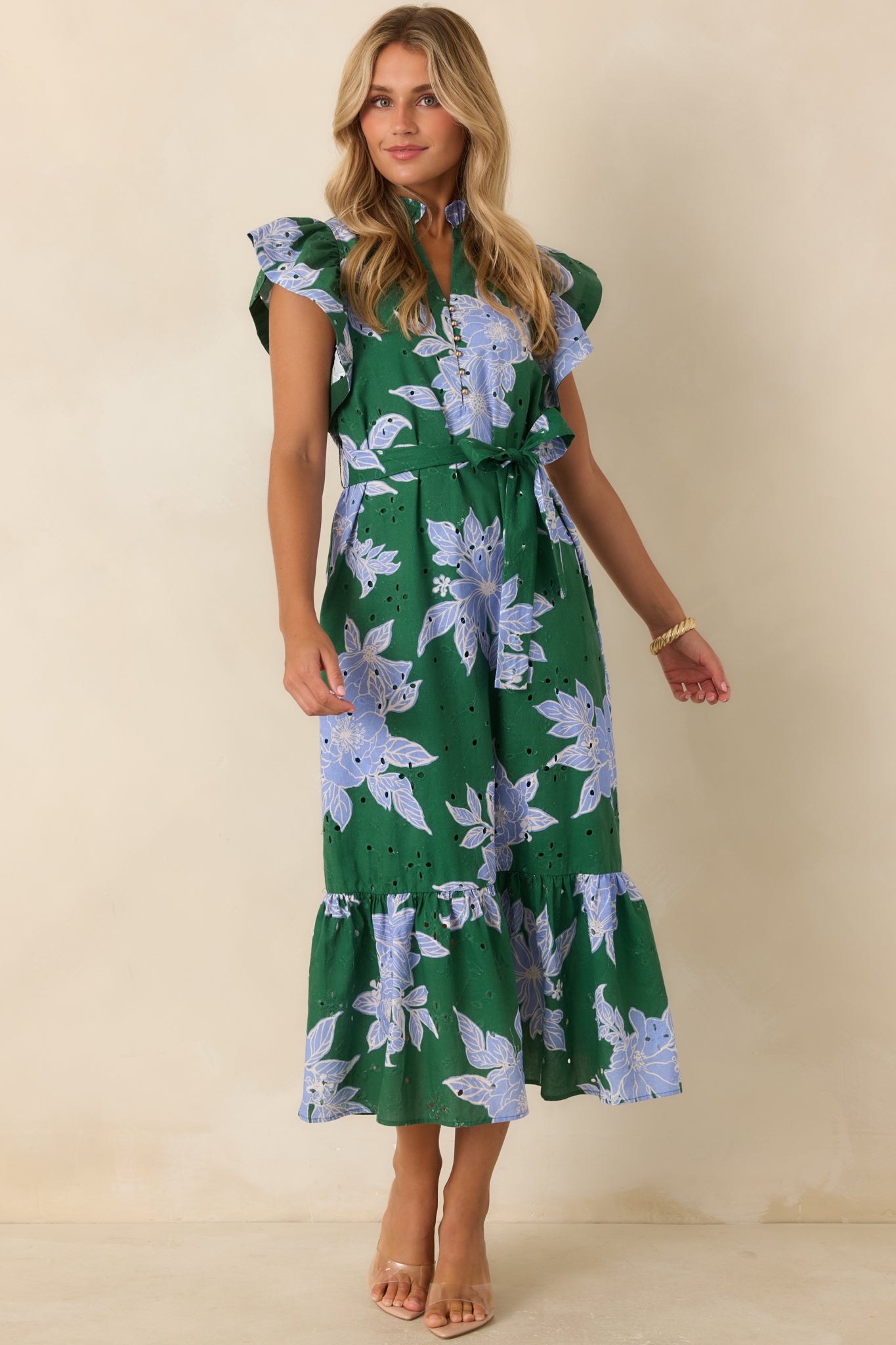 Cotton floral midi dress designed with eyelet embroidery, flutter sleeves, removable belt, and a graceful lined skirt.