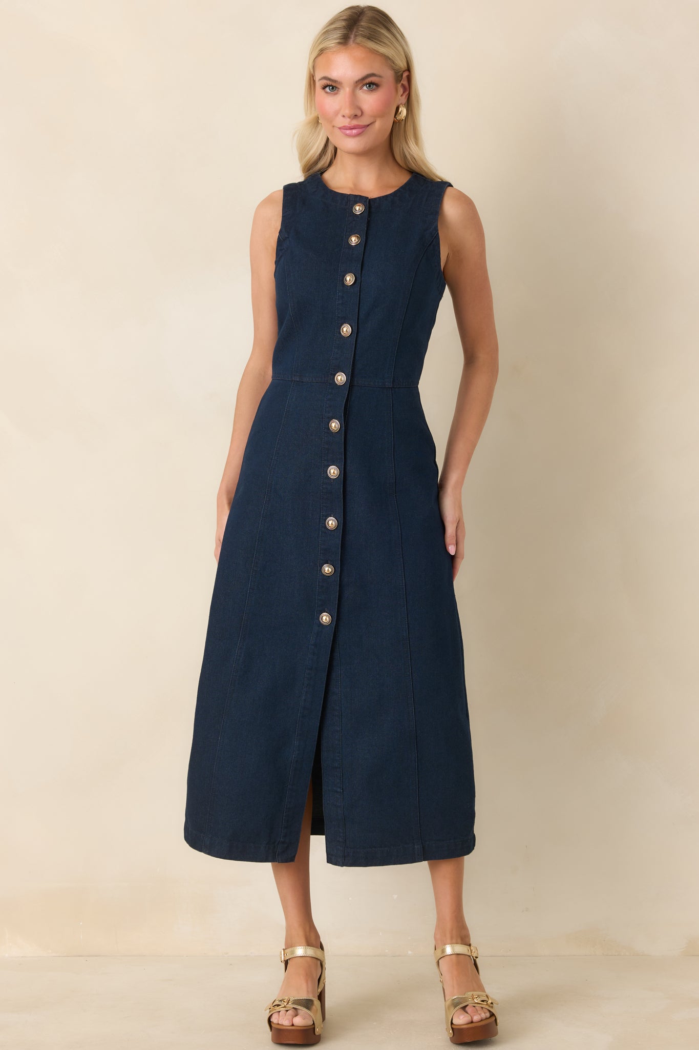 Cotton indigo midi dress with subtle tailoring, button-front closure, and a flattering sleeveless silhouette.