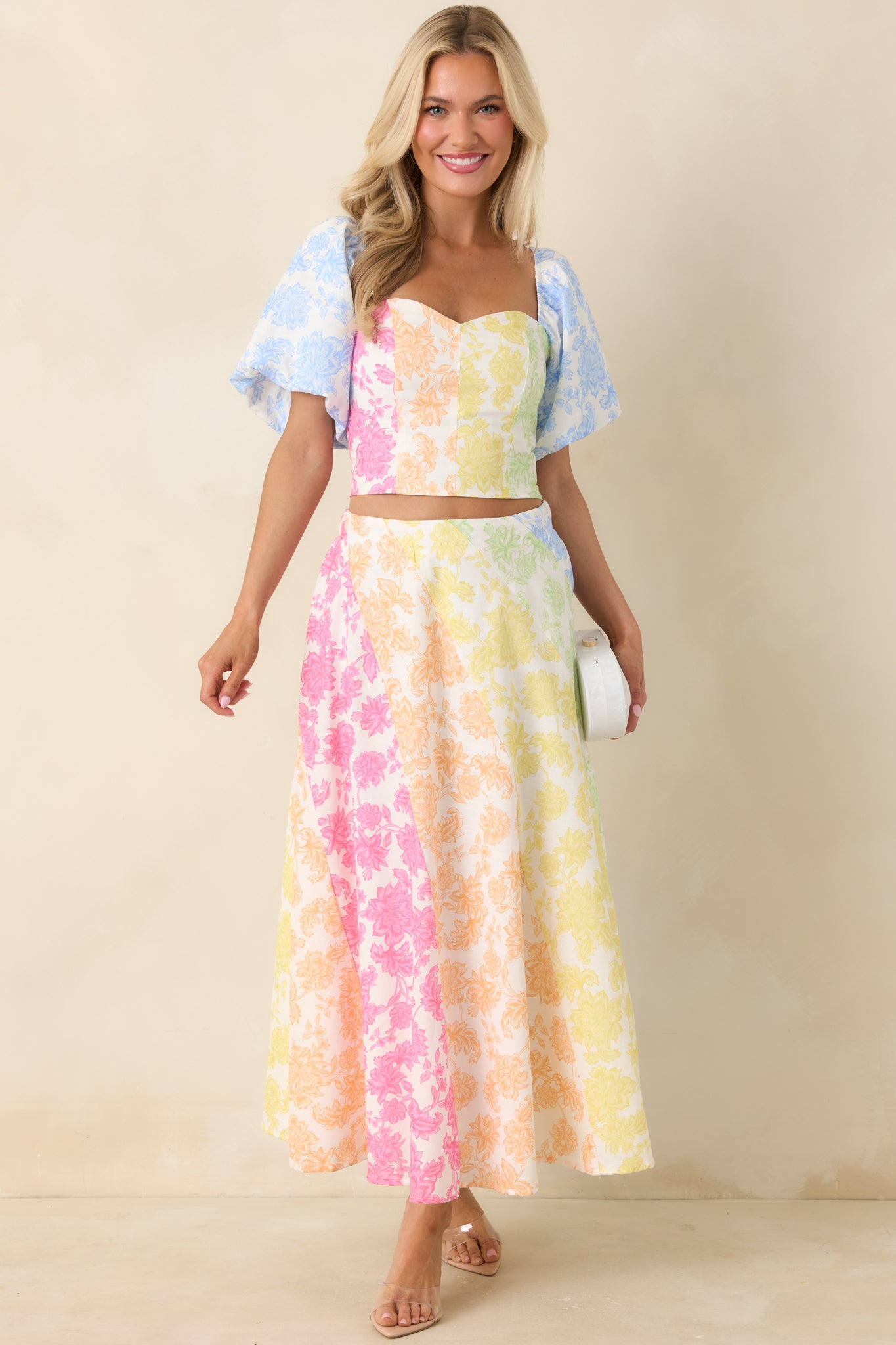 Cotton linen-blend top with sweetheart neckline, puff sleeves, and multi-color floral color-block panels.