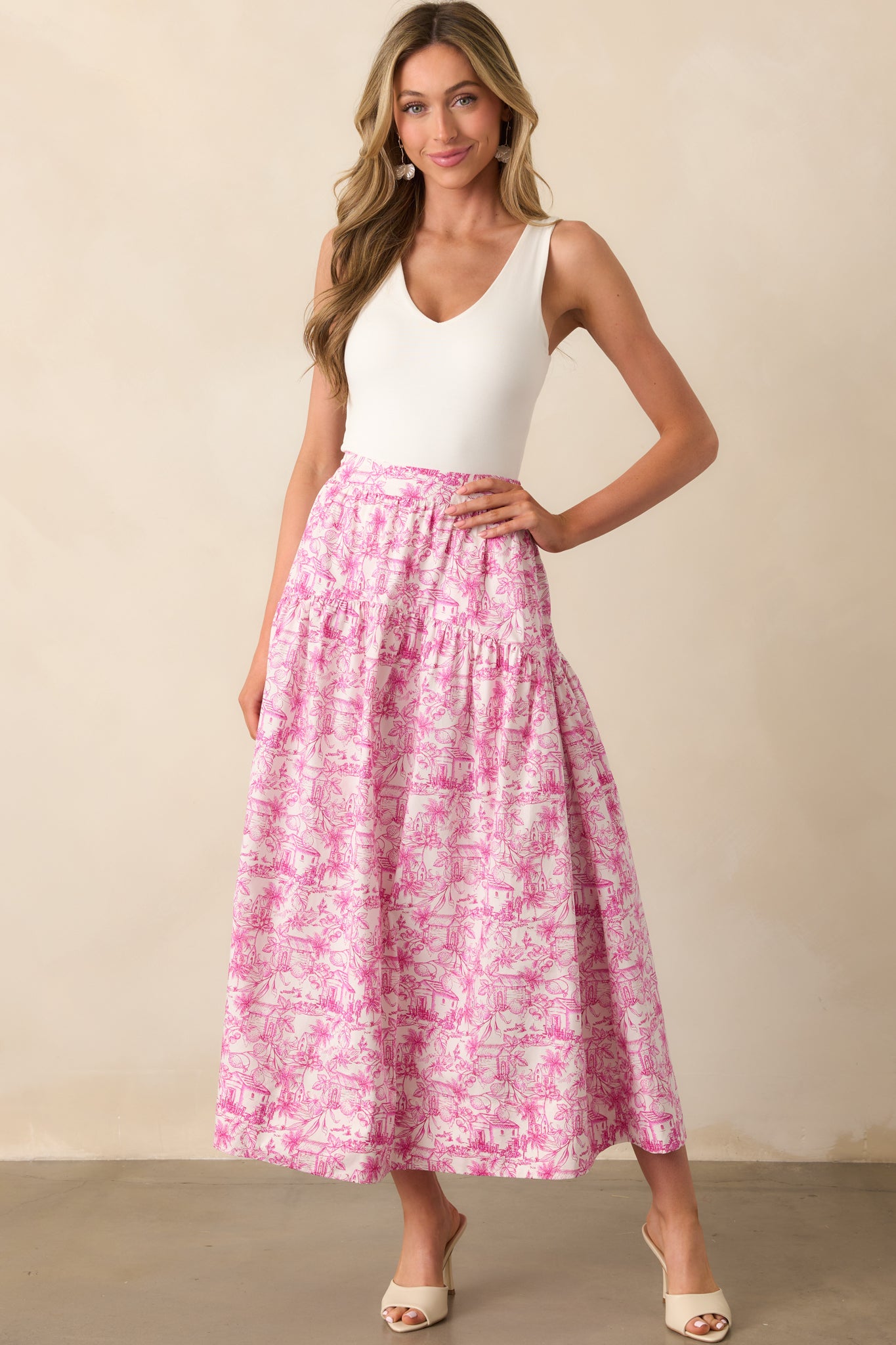 Full view of a cotton maxi skirt featuring pink toile pattern, functional pockets, and relaxed drape.