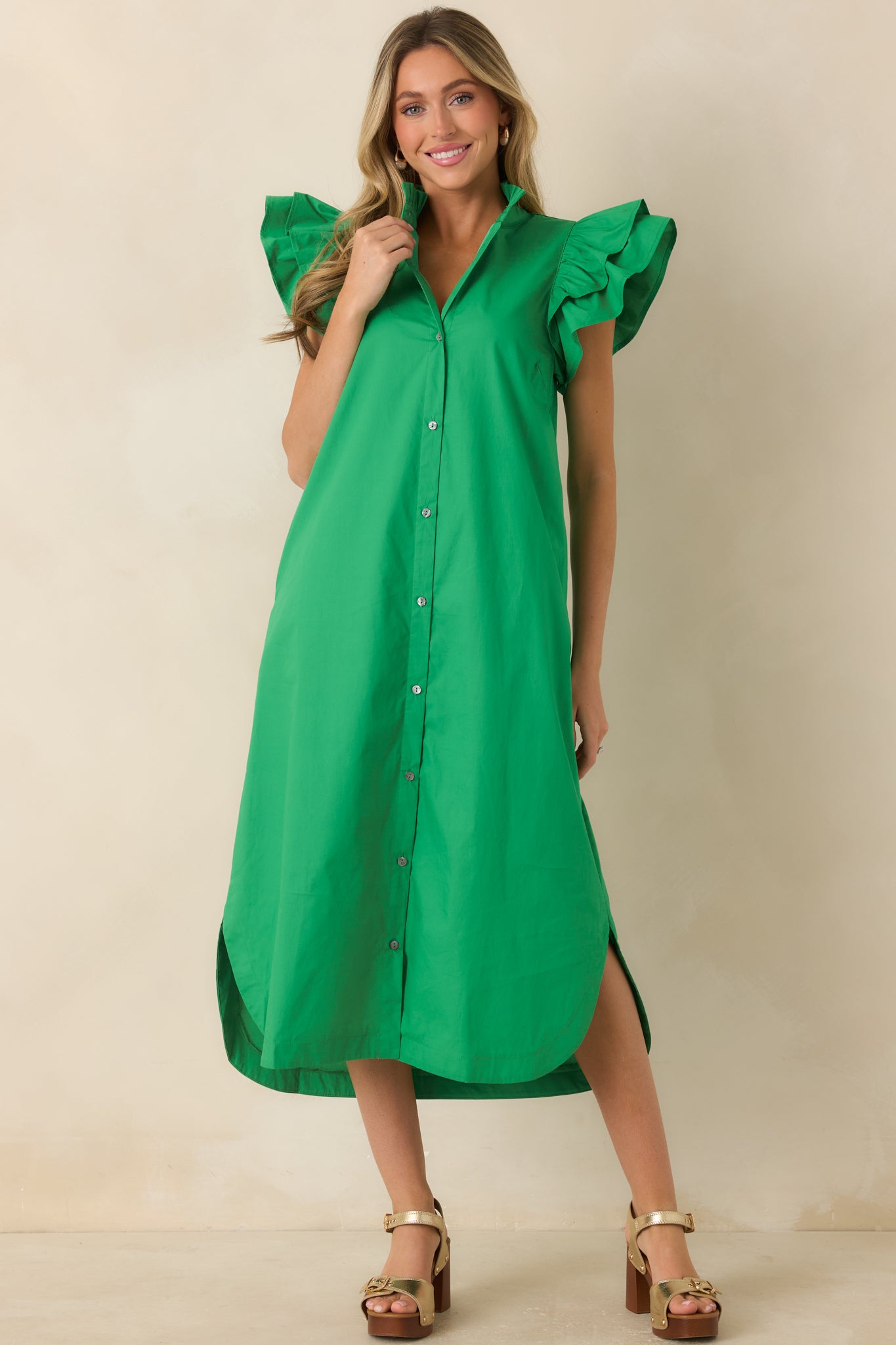 Cotton midi dress featuring a button-front design, ruffle collar, flutter sleeves, and curved hem.