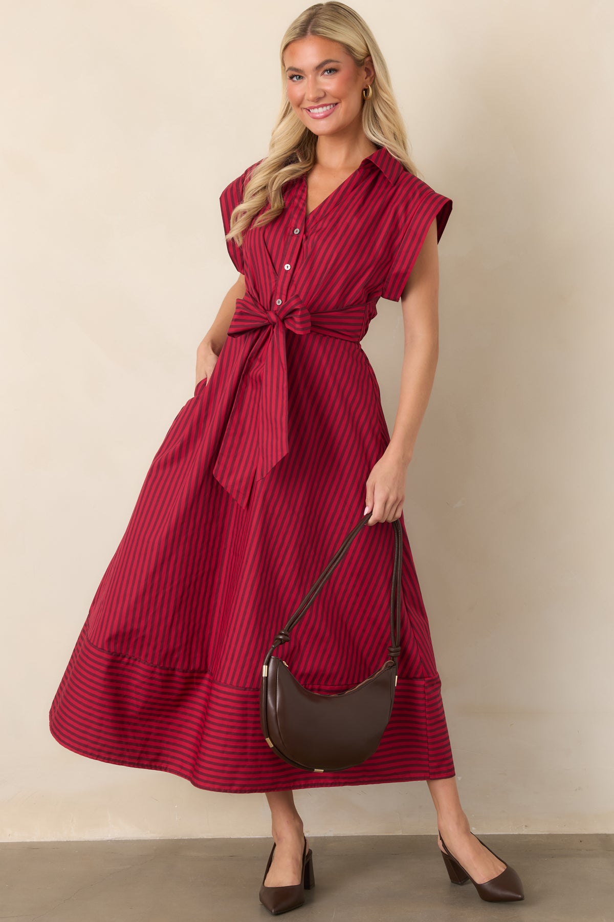 Cotton midi dress with a classic collar, cap sleeves, statement waist bow, and hidden side pockets.