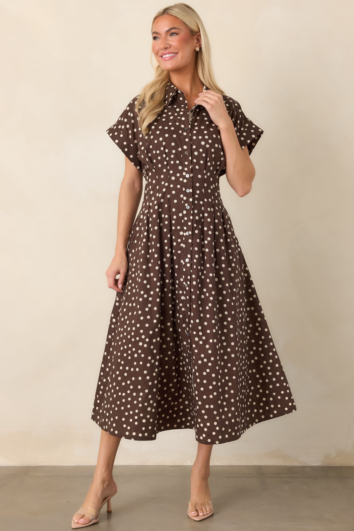 Polished cotton midi dress showcasing a collared bodice, contrasting ivory-and-brown polka dot placket, defined waist, and softly flowing skirt.