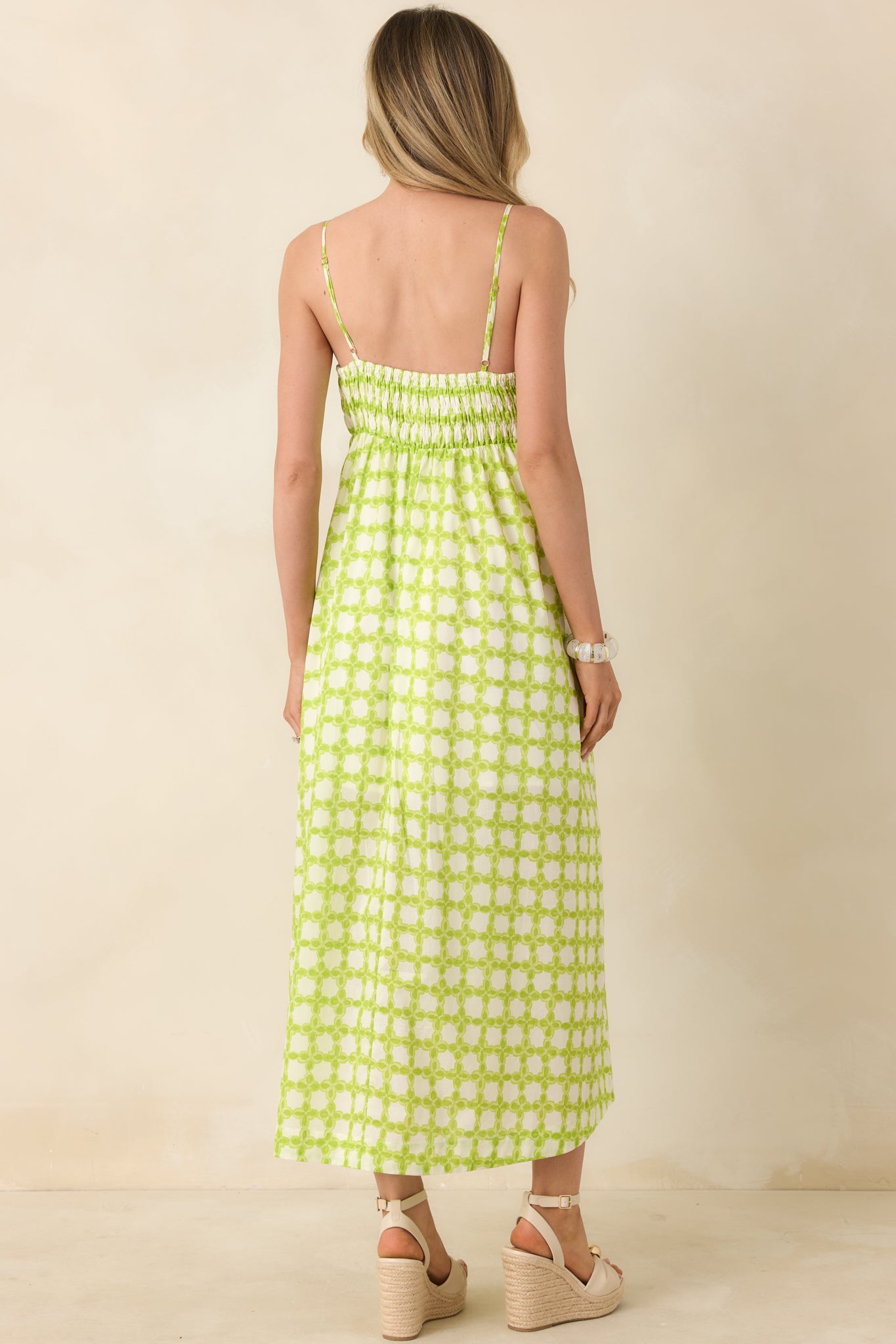 Cotton midi dress featuring a smocked rear bodice and slender adjustable straps for a flexible fit.