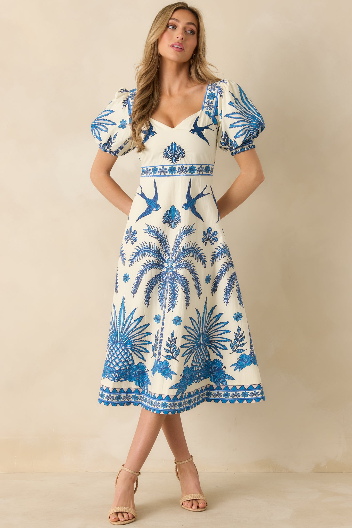 Front view of the cotton midi dress highlighting the balanced proportions and vibrant tropical print.
