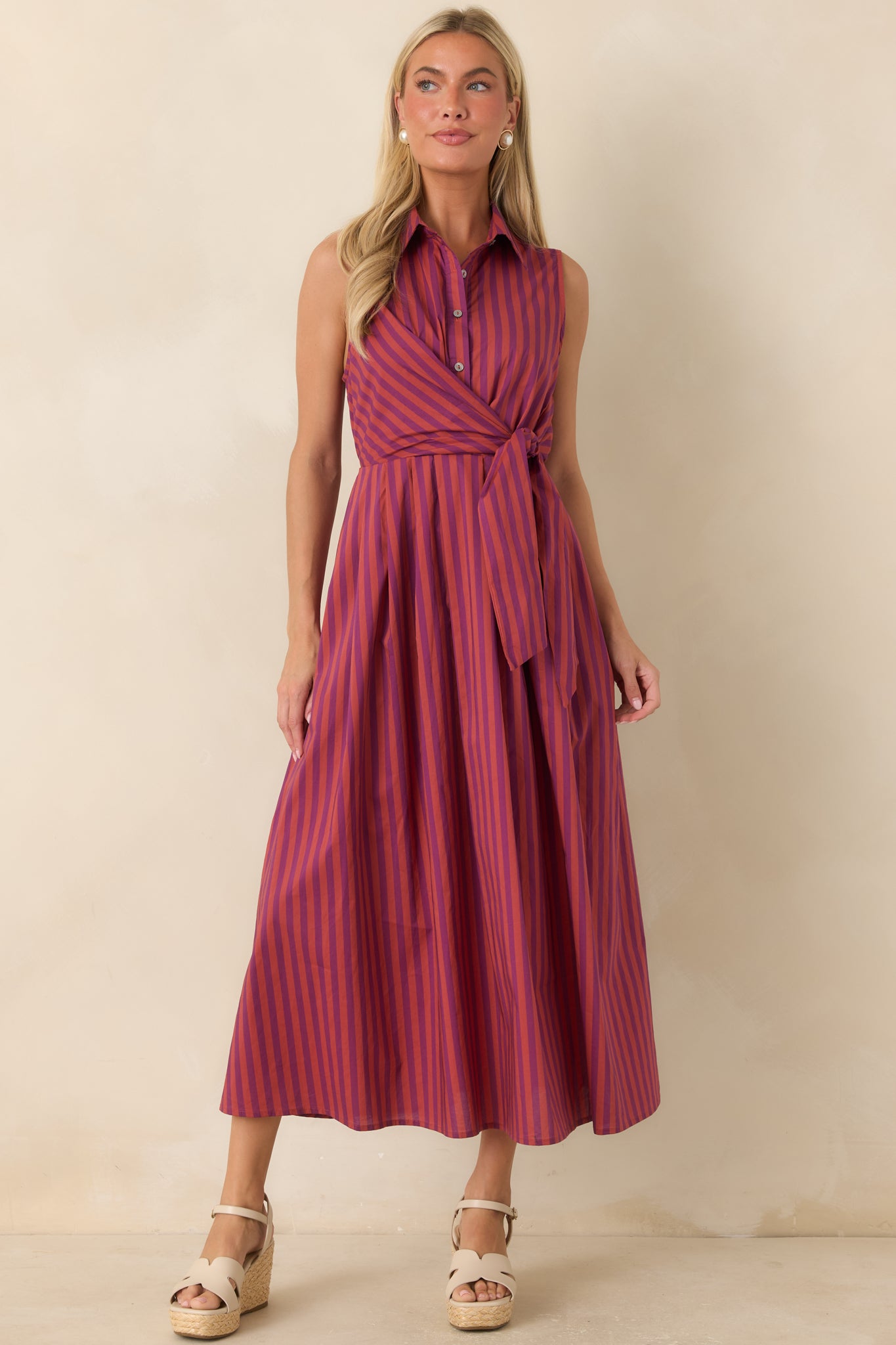 100% cotton midi dress with a collared neckline, vertical stripe pattern, button-front closure, and elegant A-line skirt.