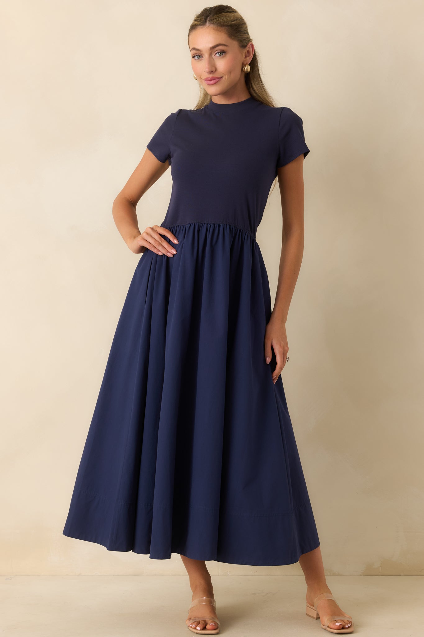 Cotton midi dress featuring a refined mock neckline, short sleeves, fitted bodice, and softly gathered skirt with a timeless silhouette.
