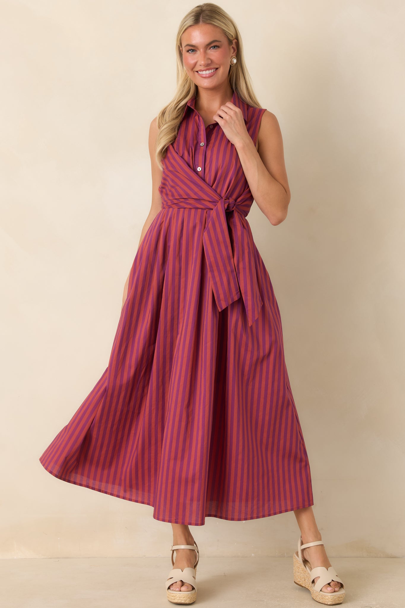 Cotton midi dress showcasing a pointed collar, button-front design, rich plum and burgundy stripes, and a relaxed A-line silhouette.