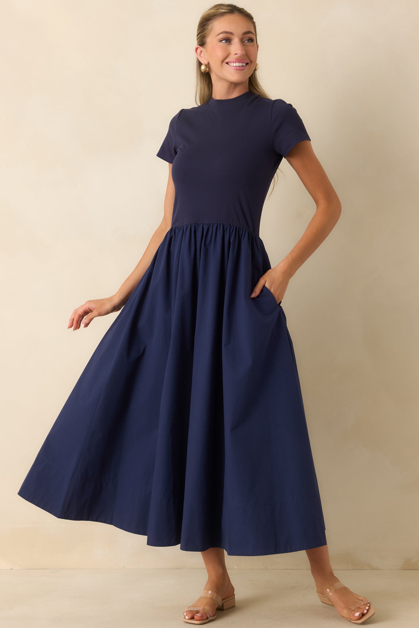 Soft cotton midi dress featuring a classic mock neckline, short sleeves, fitted bodice, and gathered full skirt.