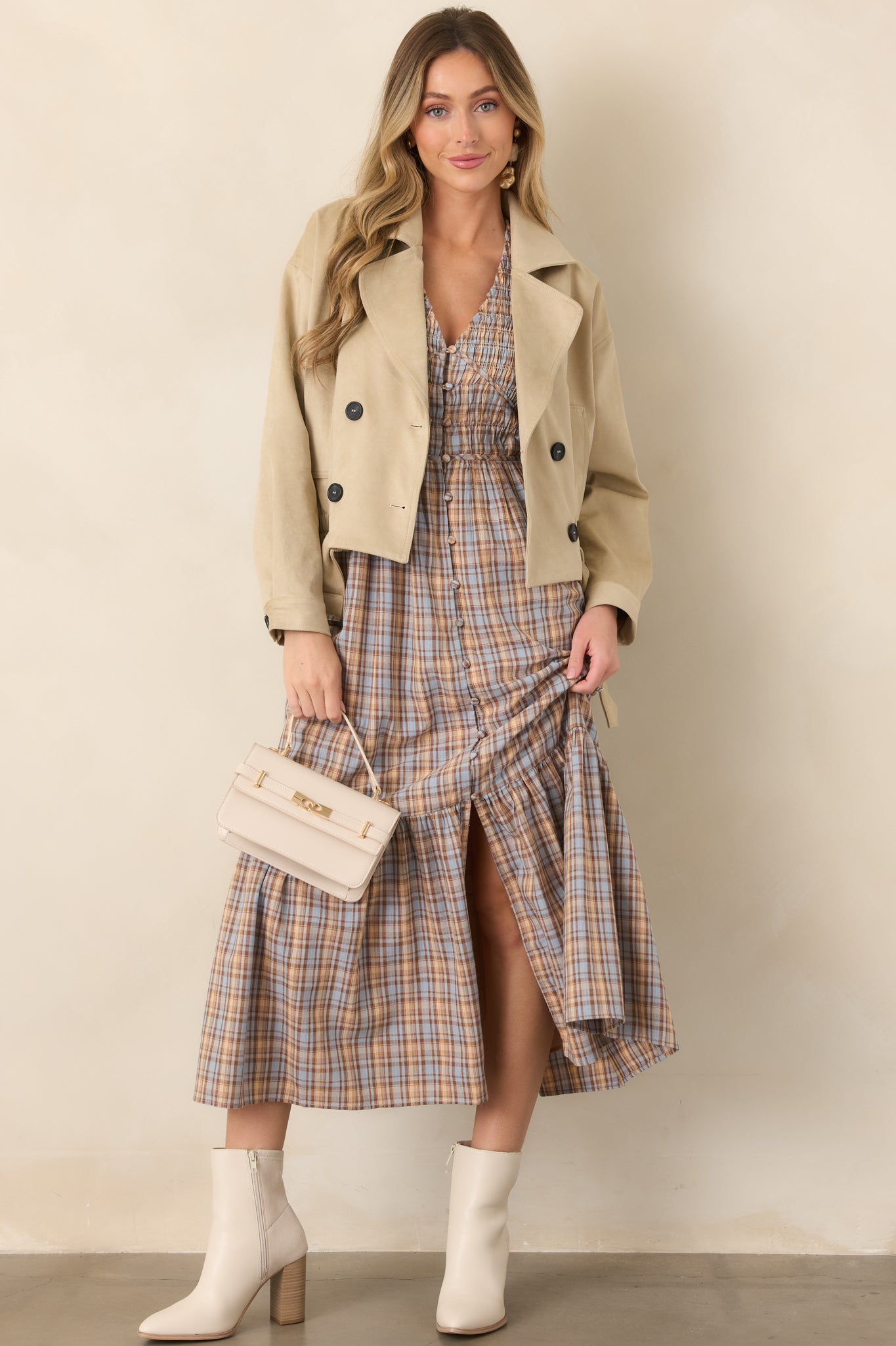 Cotton plaid midi dress showcasing a fitted smocked waist, flowing skirt, flutter sleeves, and convenient side pockets.