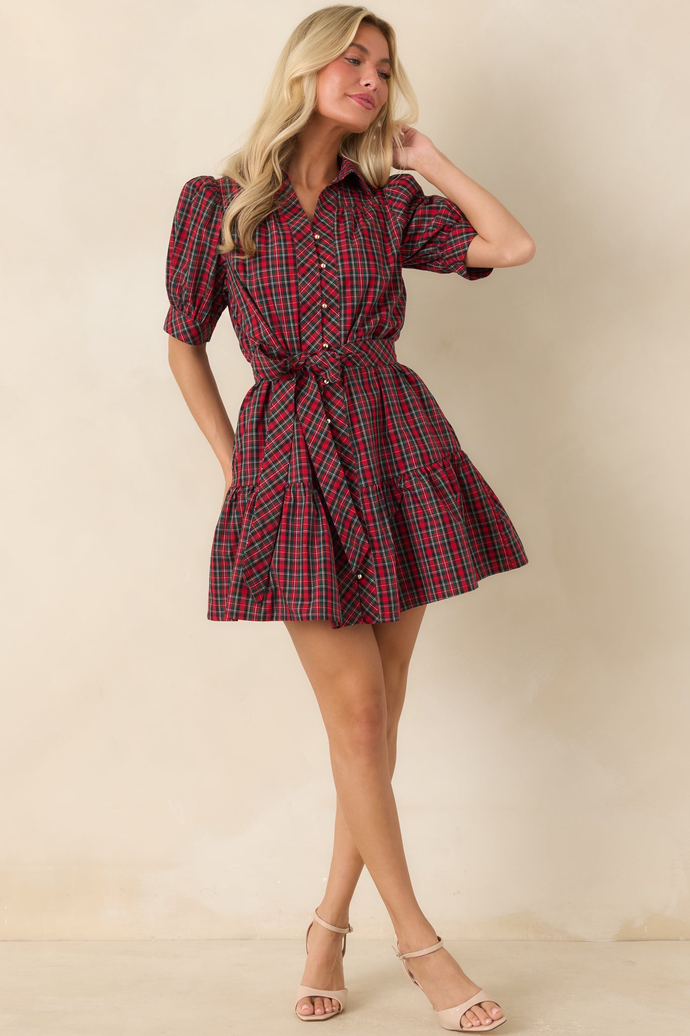 Cotton plaid mini dress showcasing gathered puff sleeves, a button-front closure, waist-defining tie belt, and tiered skirt.