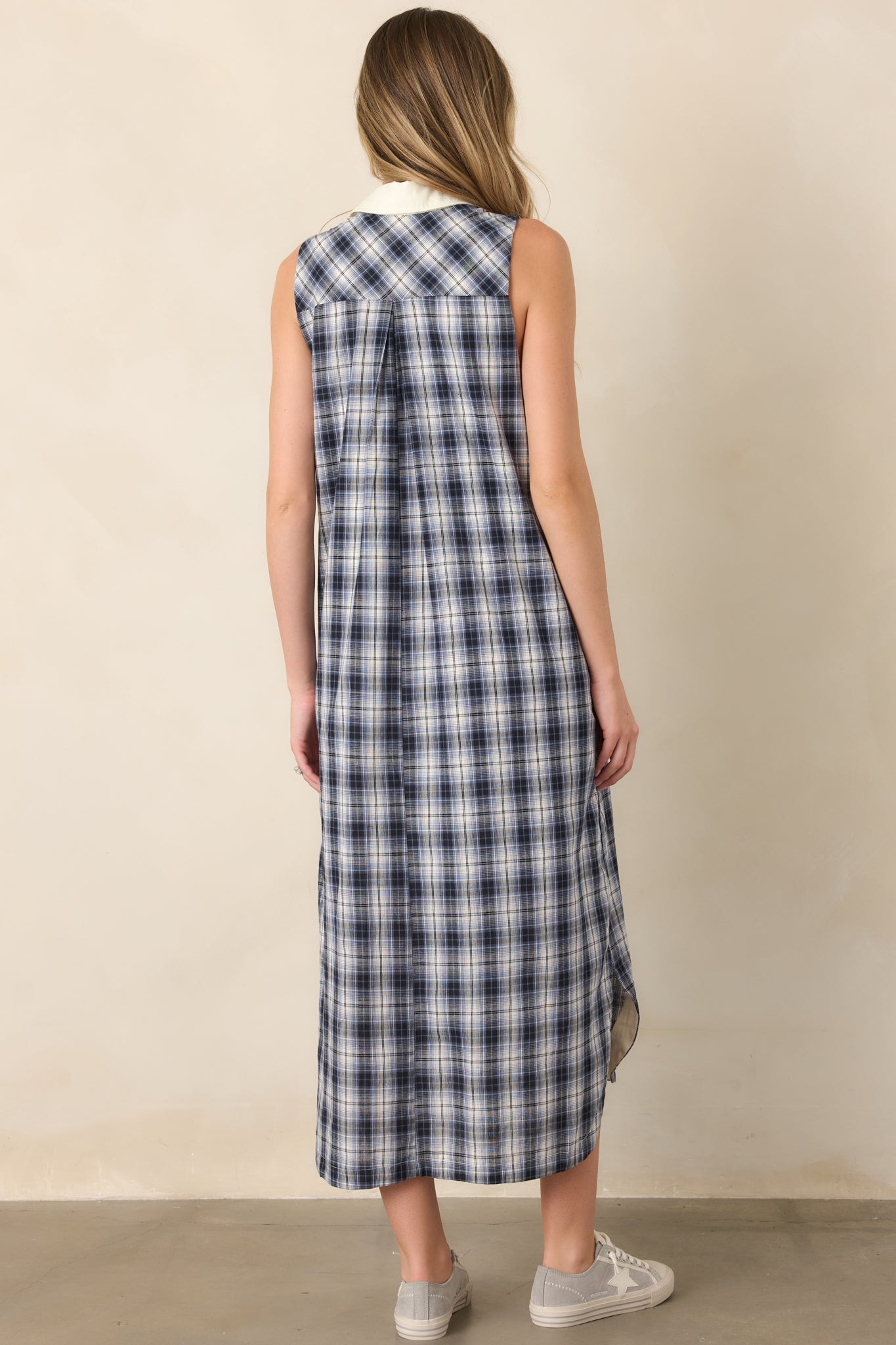 Rear view of the relaxed cotton sleeveless dress showing its clean silhouette, full lining, and comfortable drape through the body.