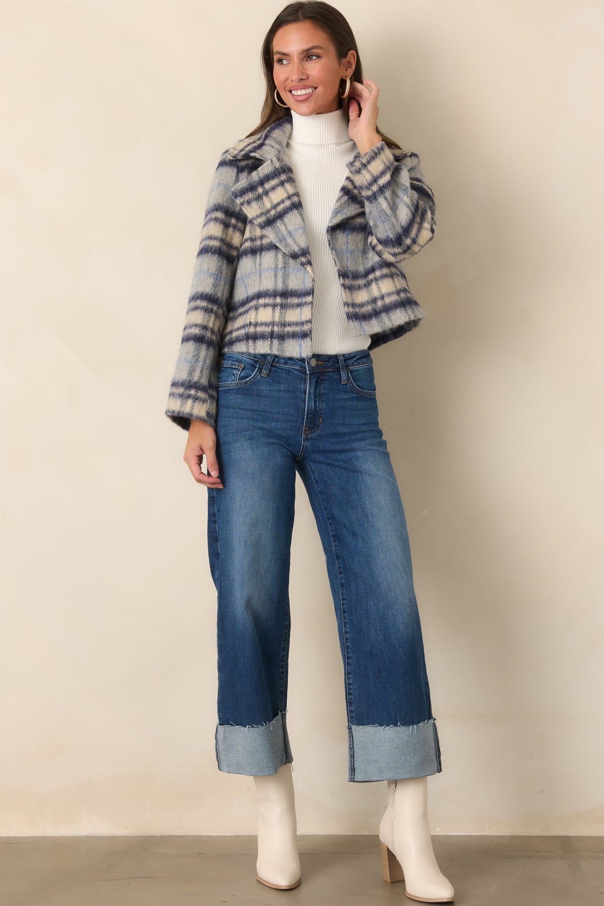 Cotton-rich stretch denim jeans featuring a modern wide-leg silhouette and raw-edge cuffs.