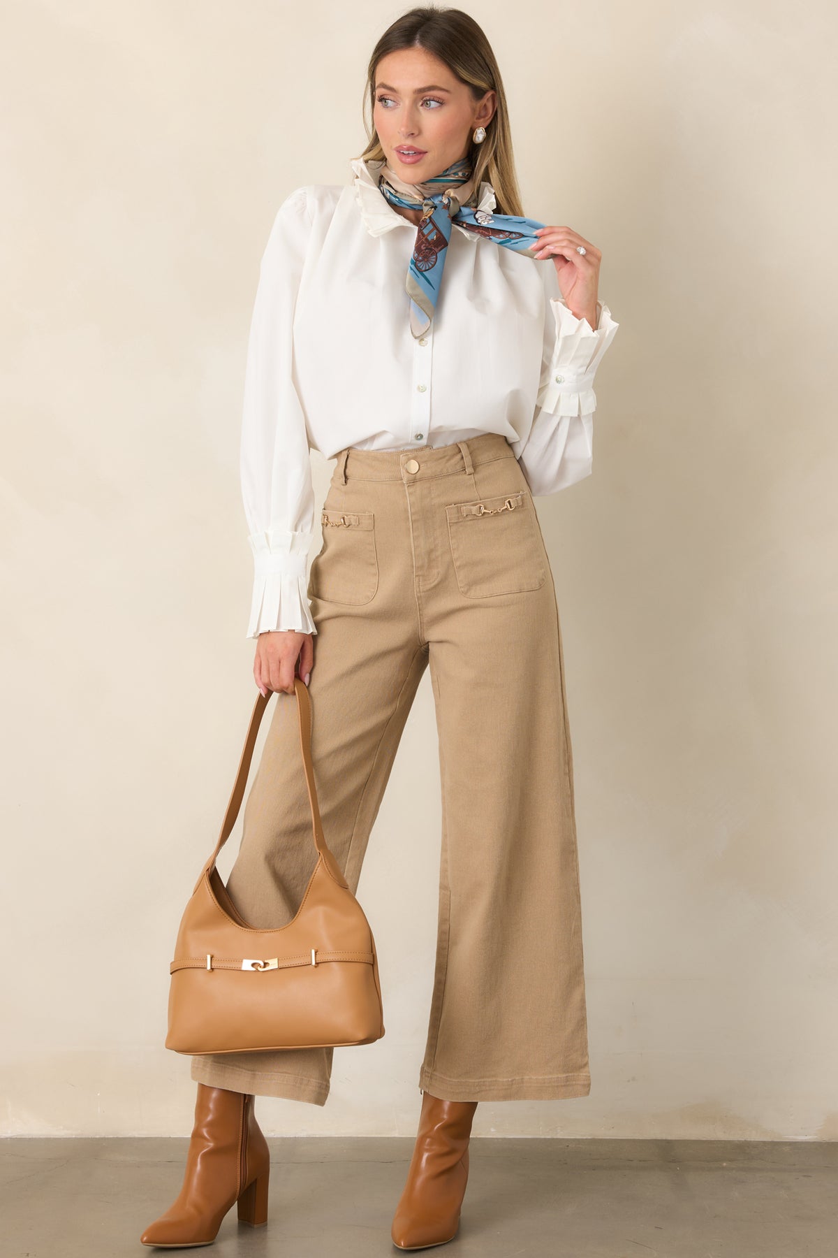 100% cotton top with a detailed ruffled stand neckline, button front, and softly gathered sleeves.