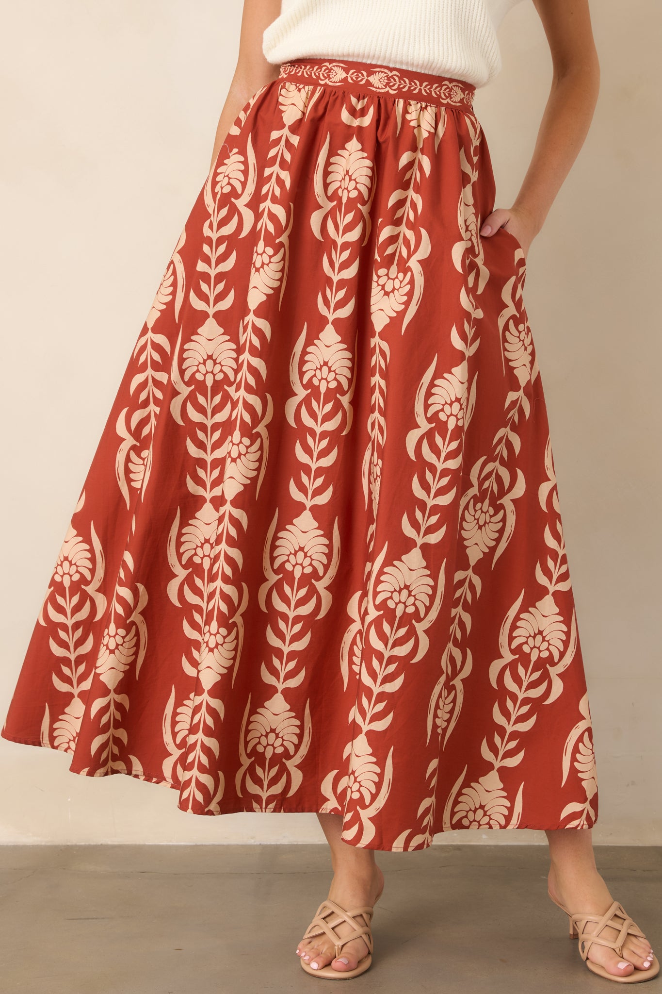 Close view of the cotton skirt highlighting its smooth front waistband and softly flowing A-line shape.