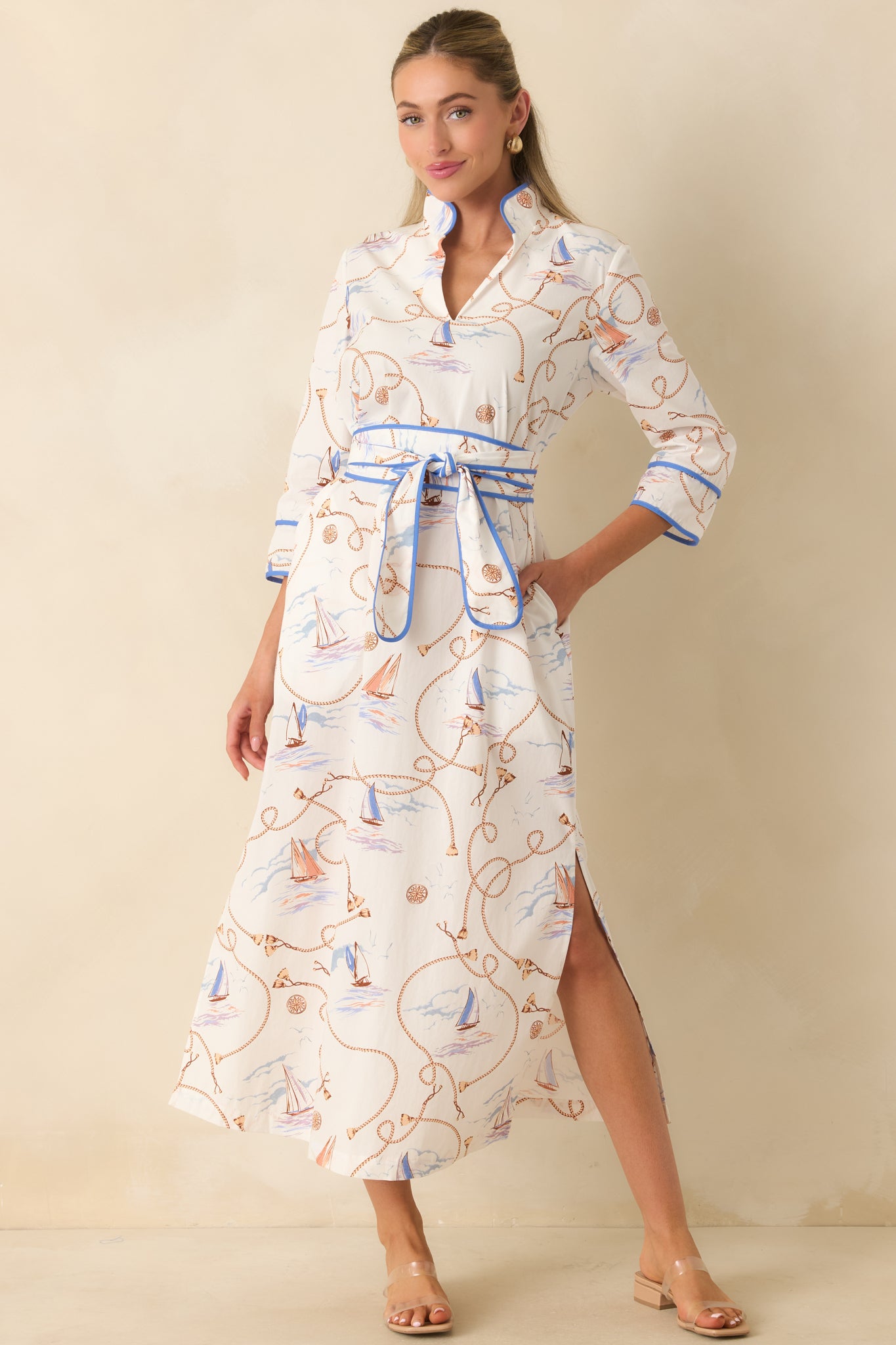 Breathable cotton maxi dress featuring a stand collar, split neckline, contrast blue piping, three-quarter sleeves, and a self-tie sash belt.