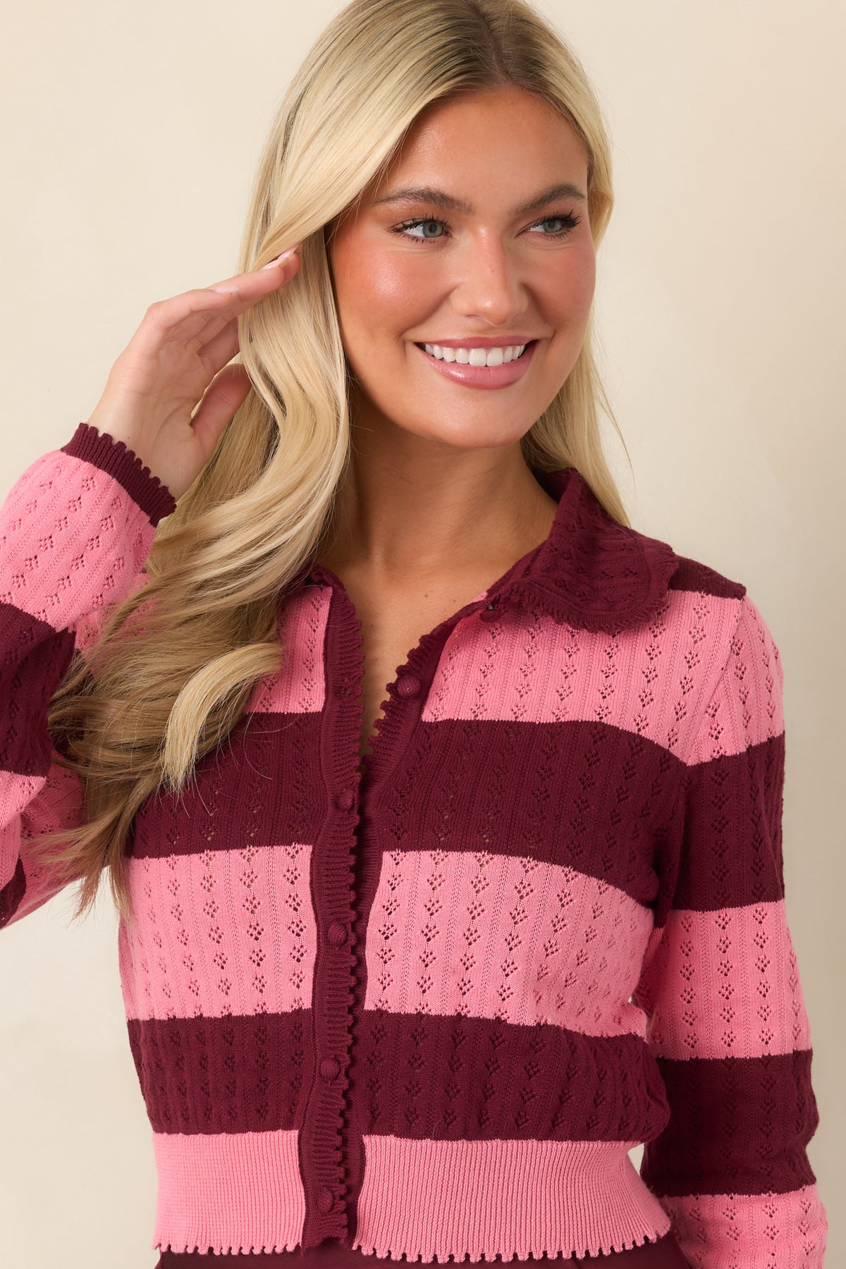 Cotton knit cardigan showcasing the rounded wine collar and matching wine button front.