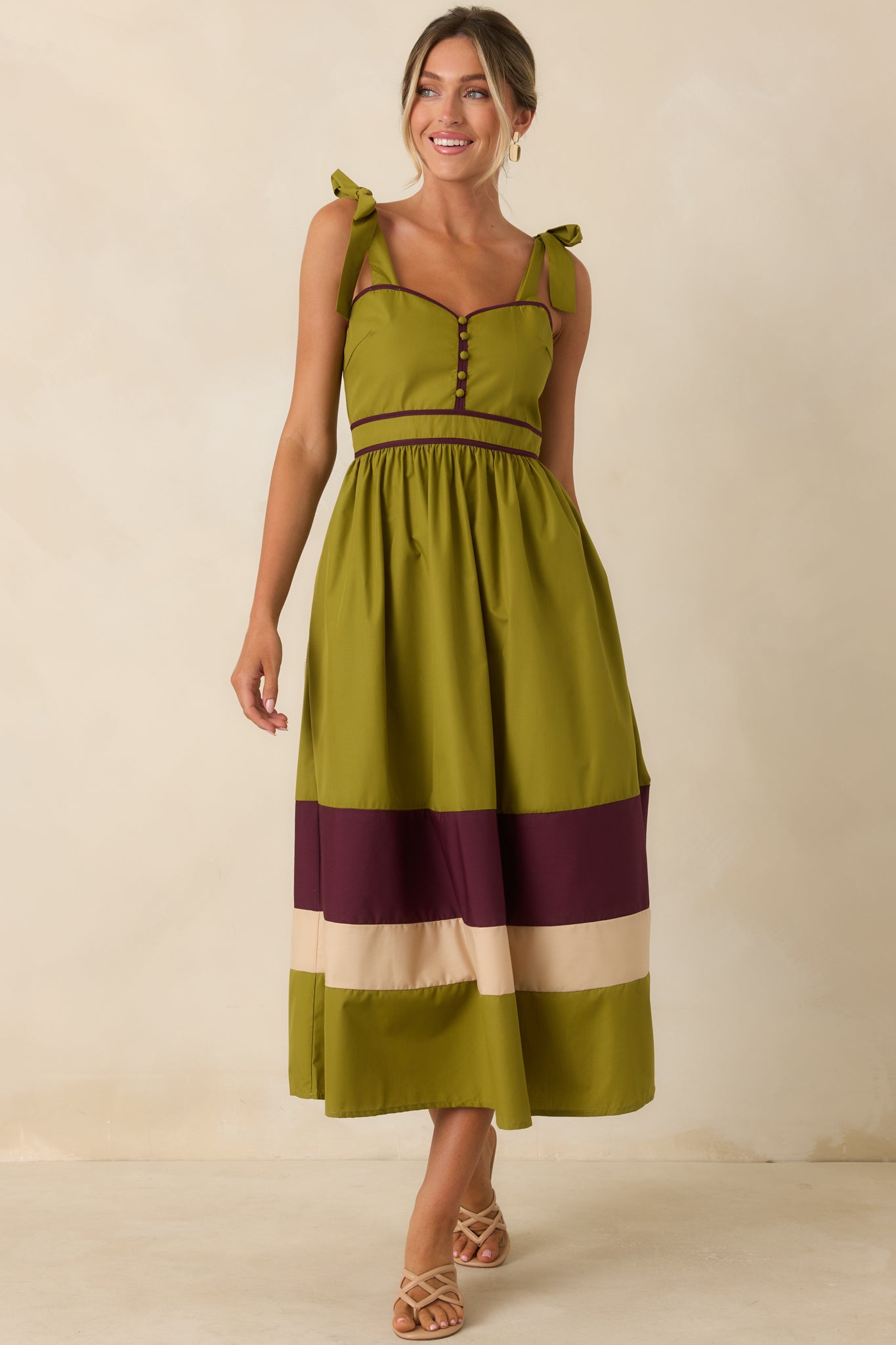 Printed midi dress designed with covered buttons, gathered skirt volume, and a vibrant berry trimmed hem.