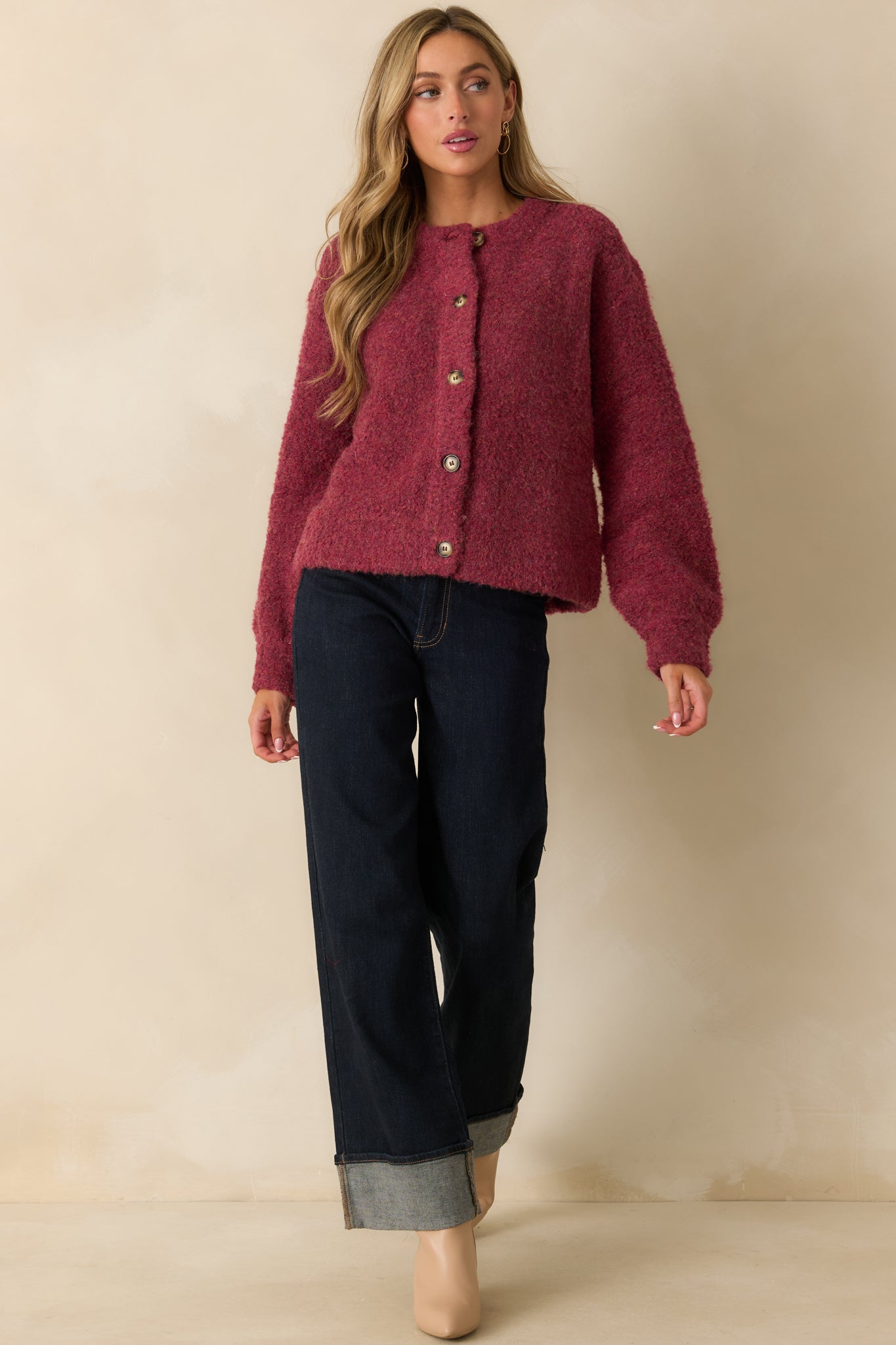 Cozy cranberry cardigan with a crew neckline and long sleeves, highlighting its easy, refined fit.