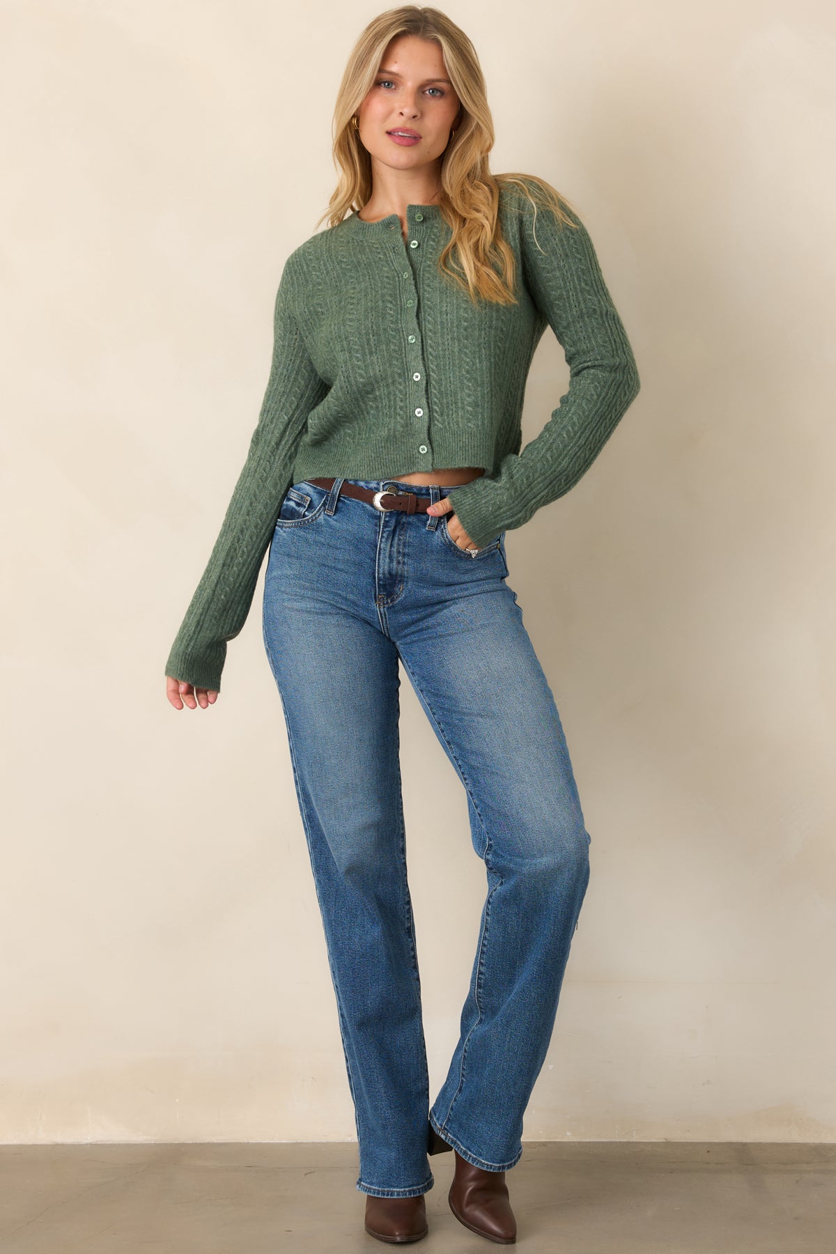 Cozy cropped cardigan with a tonal button-front design, round neckline, long sleeves, and ribbed cuffs and hem.