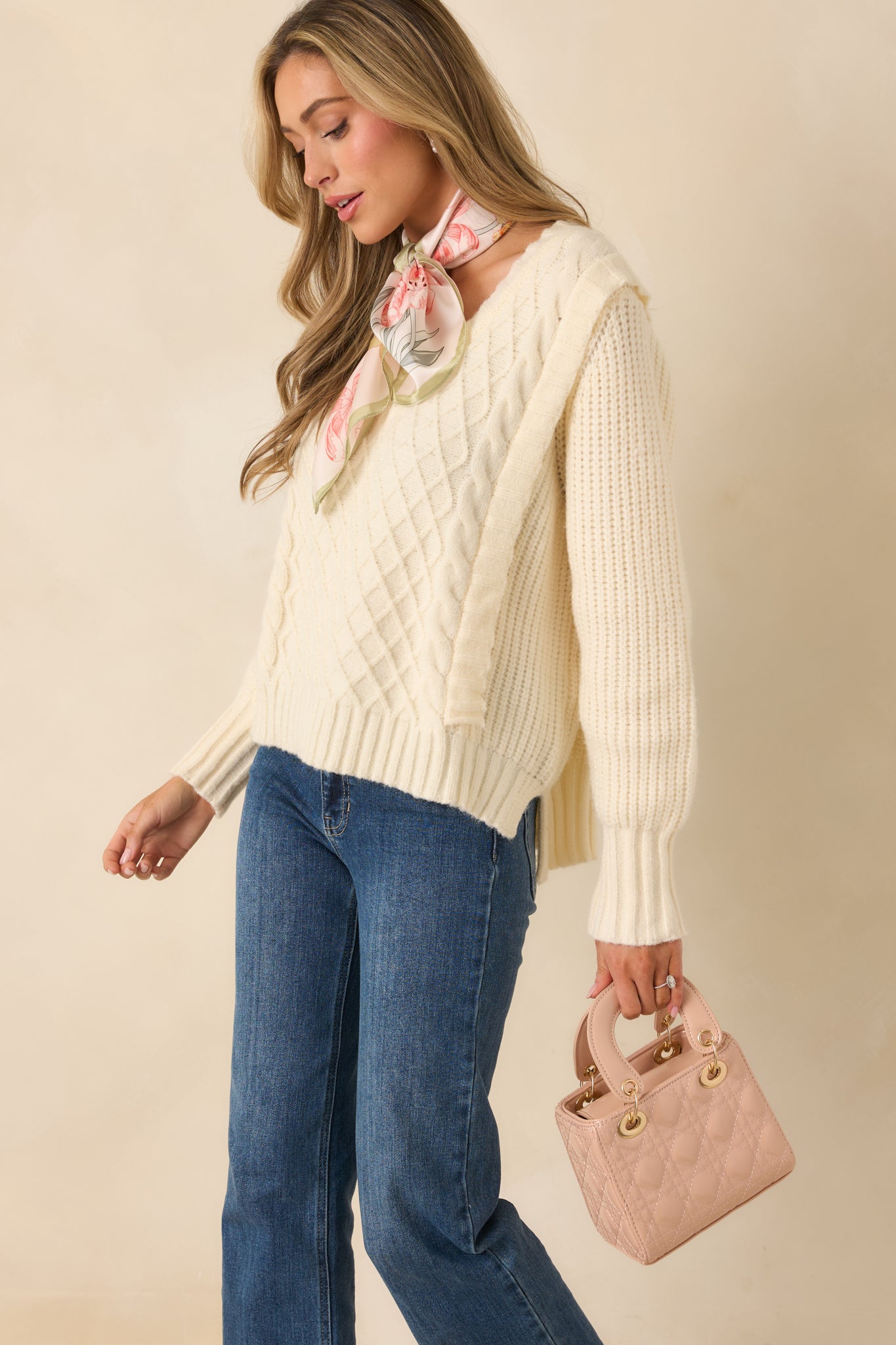 Cozy ivory sweater with a slightly relaxed silhouette and layered textured knit pattern.