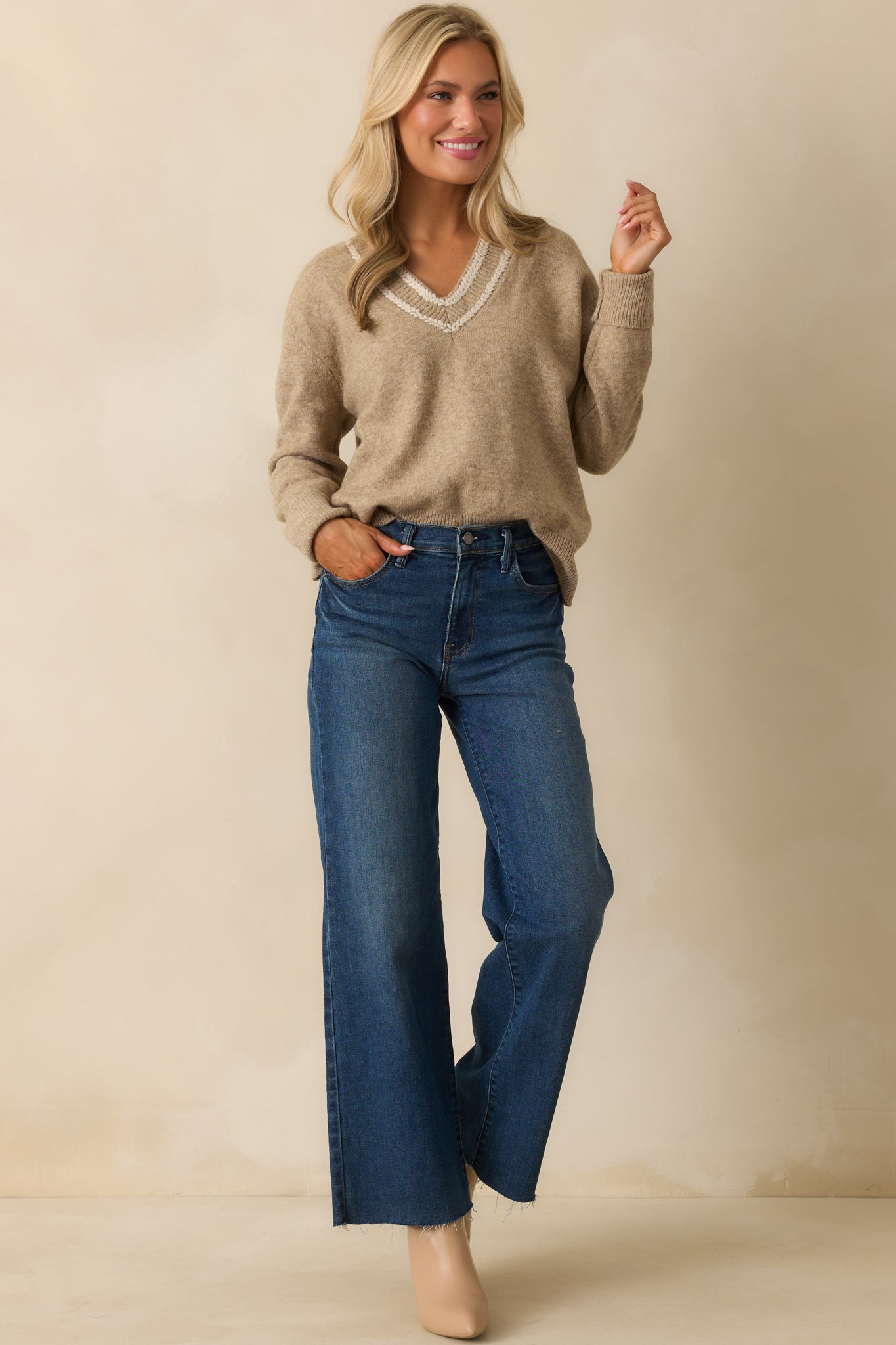 Cozy knit sweater in tan with long sleeves and subtle ribbed detailing at the cuffs and hem.