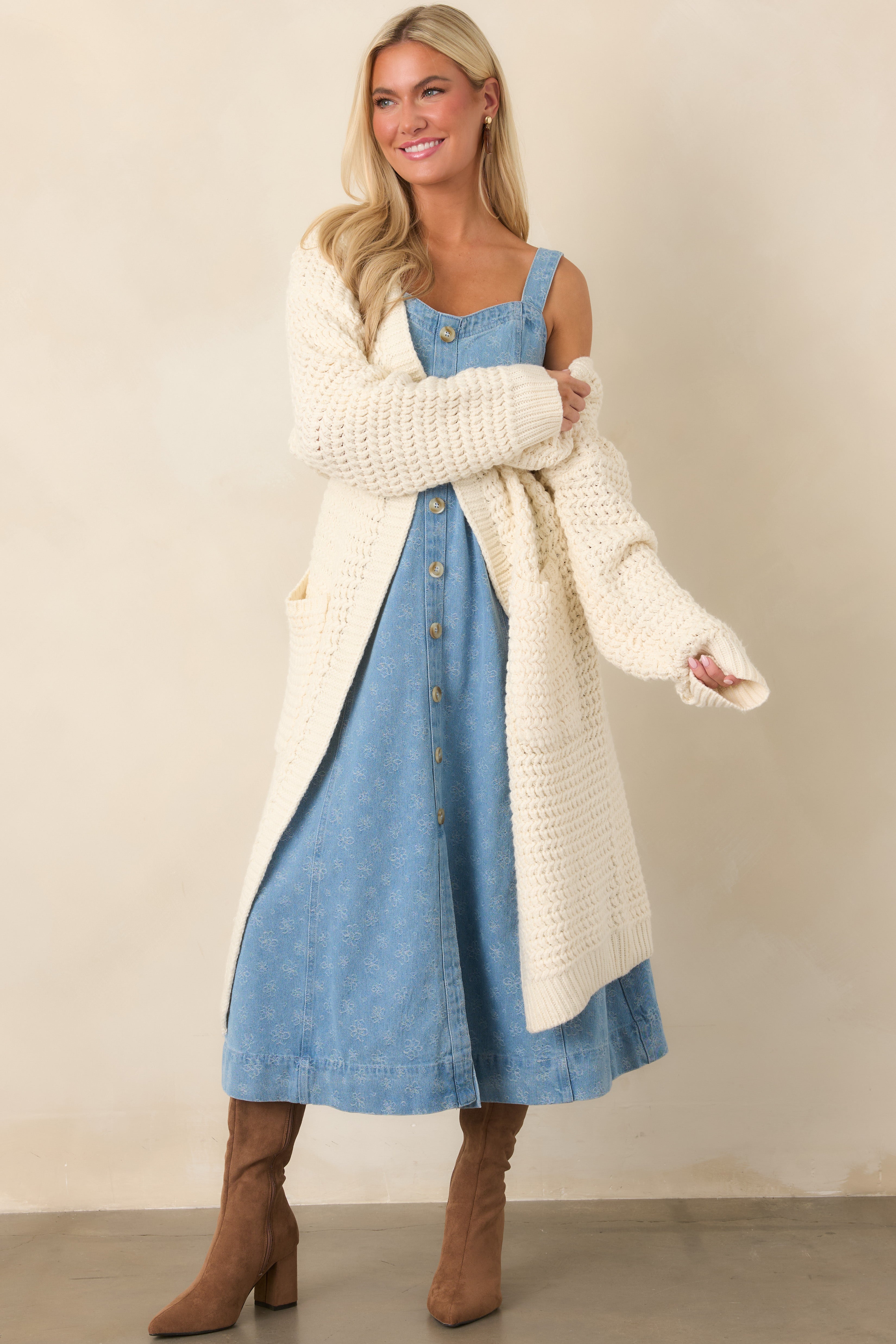 Longline cream cardigan showcasing its chunky textured knit, roomy fit, and practical front patch pockets.
